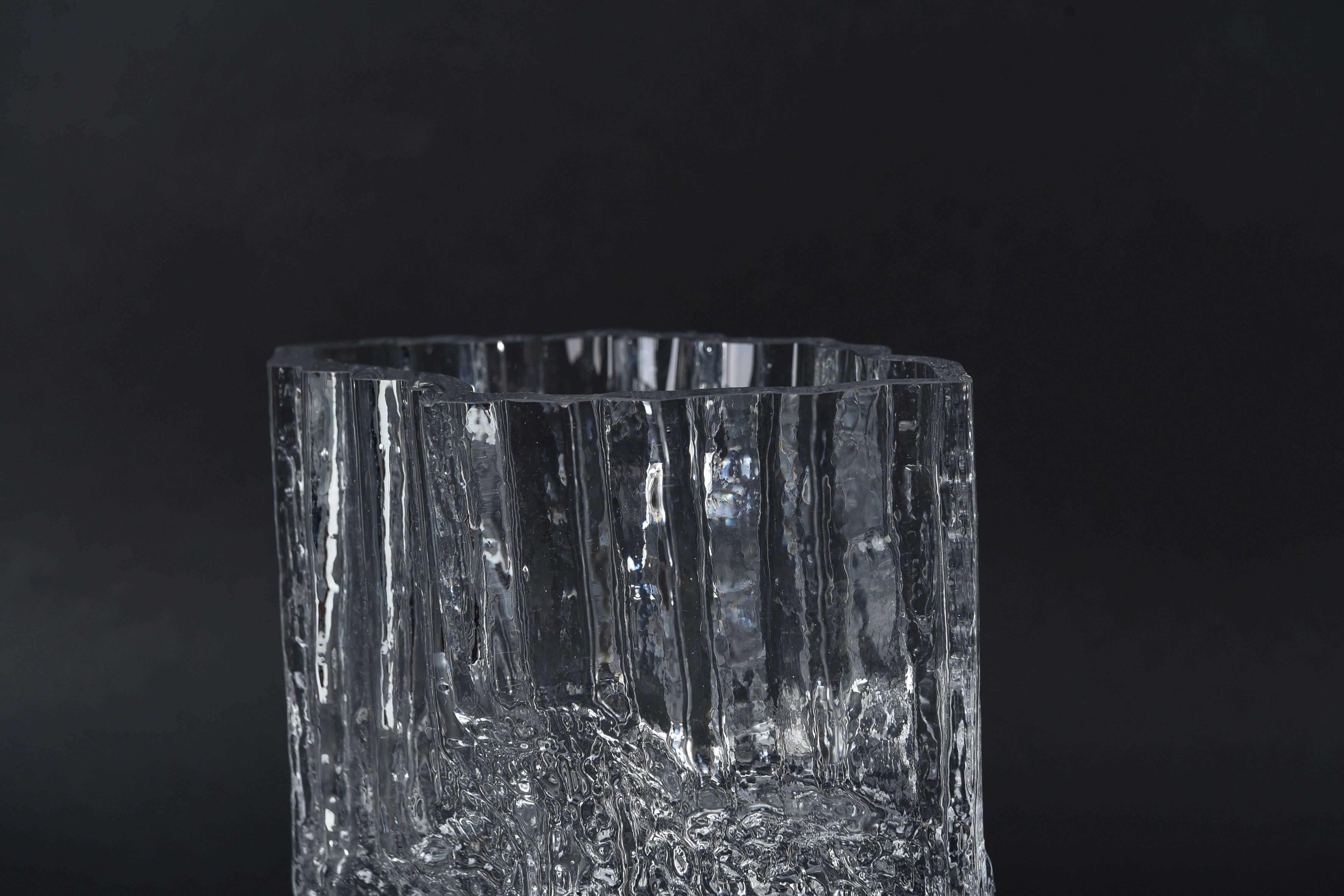 A wonderful clear, molded ice glass vase by Tapio Wirkkala for Iittala, circa 1970s. Very interesting shape and texture, resembling that of ice.