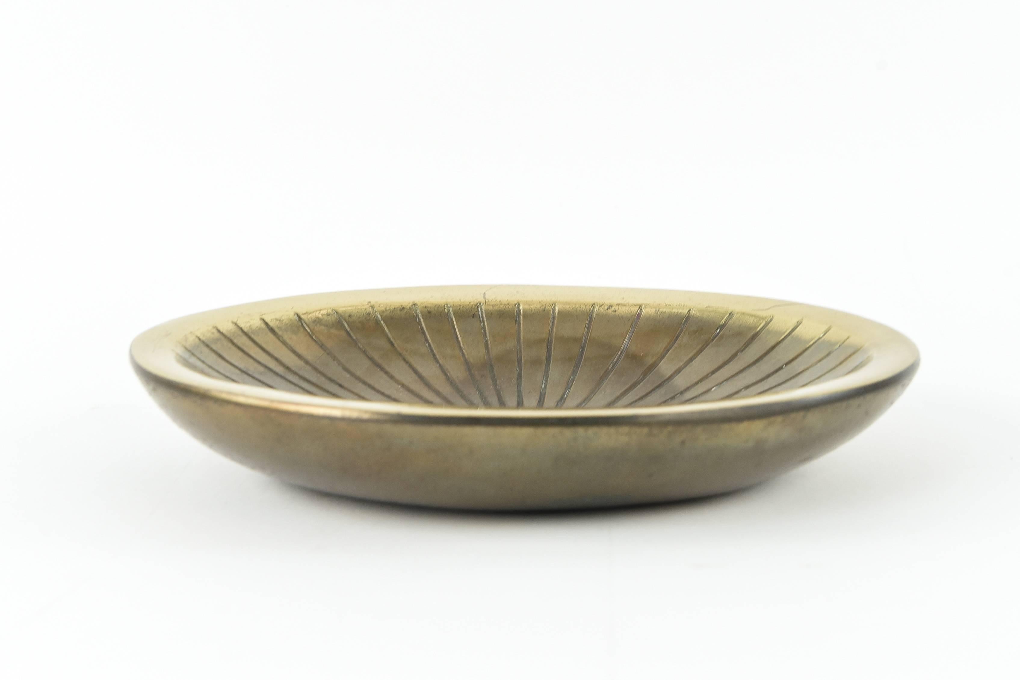 A beautiful bowl to be a great accent piece on any table or shelf, this Ben Seibel bowl has a very warm patina and the original sunburst design illuminates the atomic style.