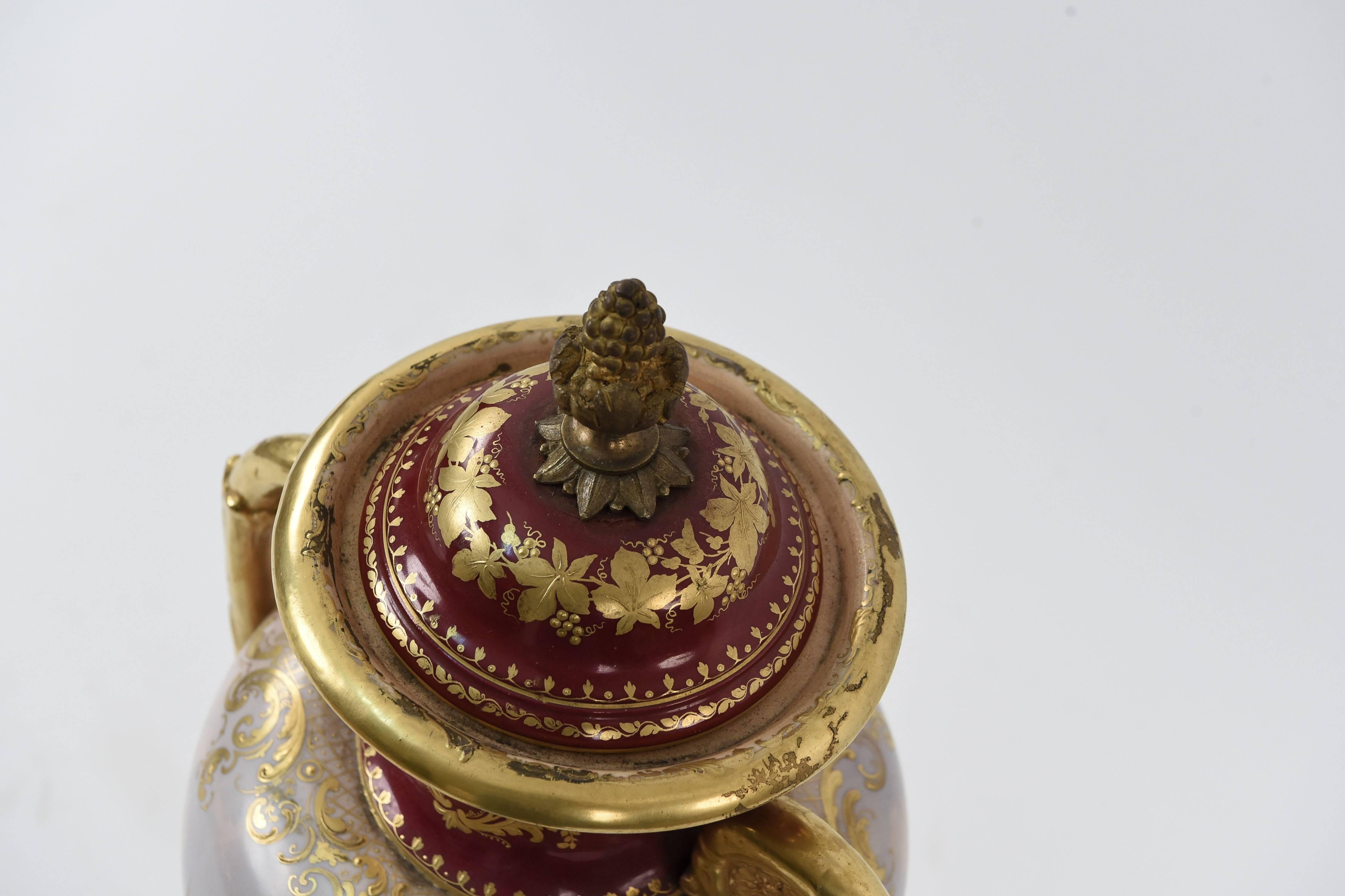 A decorated porcelain urn of great quality by Austrian maker Royal Vienna. With a beautiful scene depicting a woman surrounded by cherubs. Has beehive marking to base.