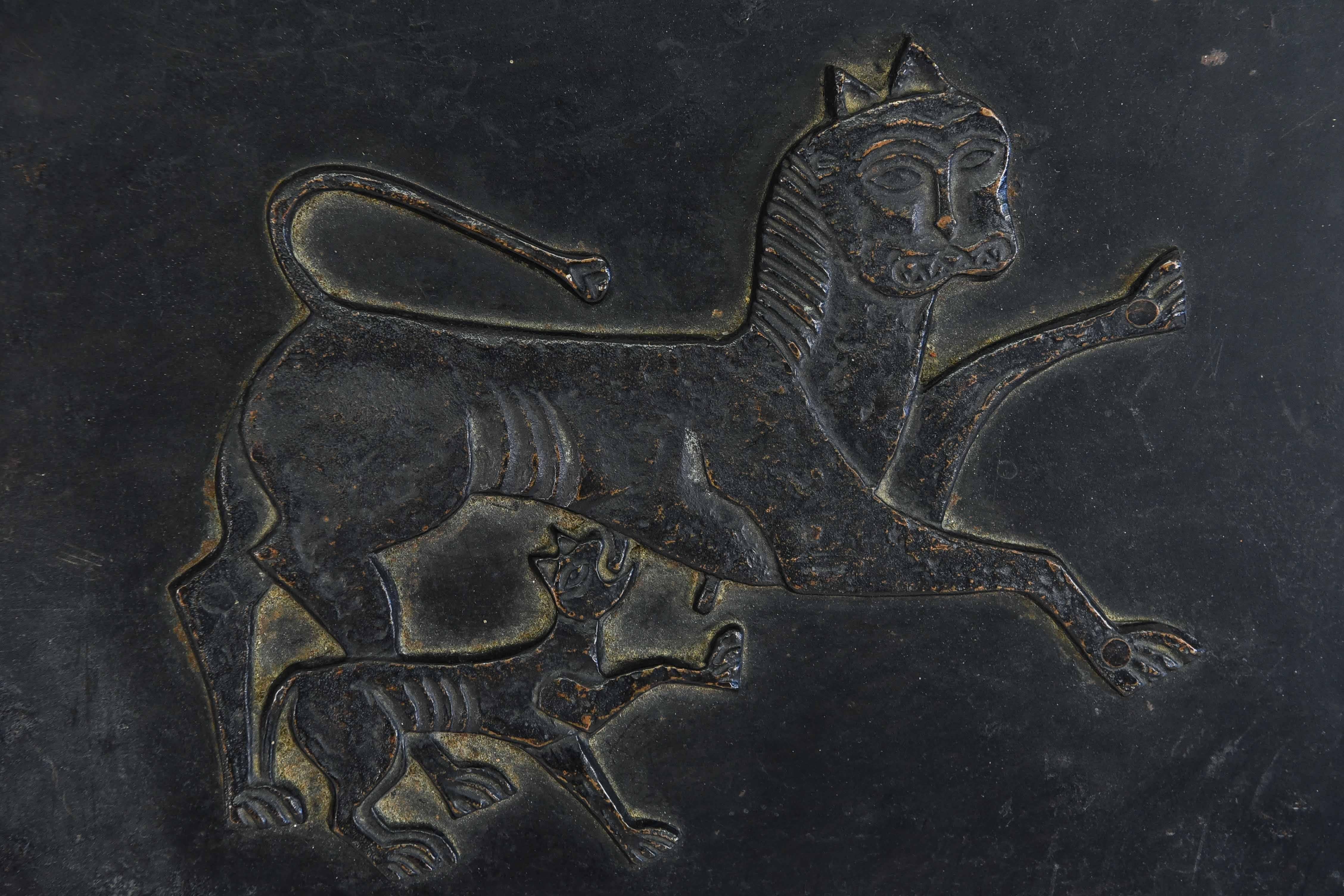 A Czechoslovakian hammered copper and steel photo album depicting a feline and cub on the front. Hallmarked on binding side with glyphs and the letters OHG.