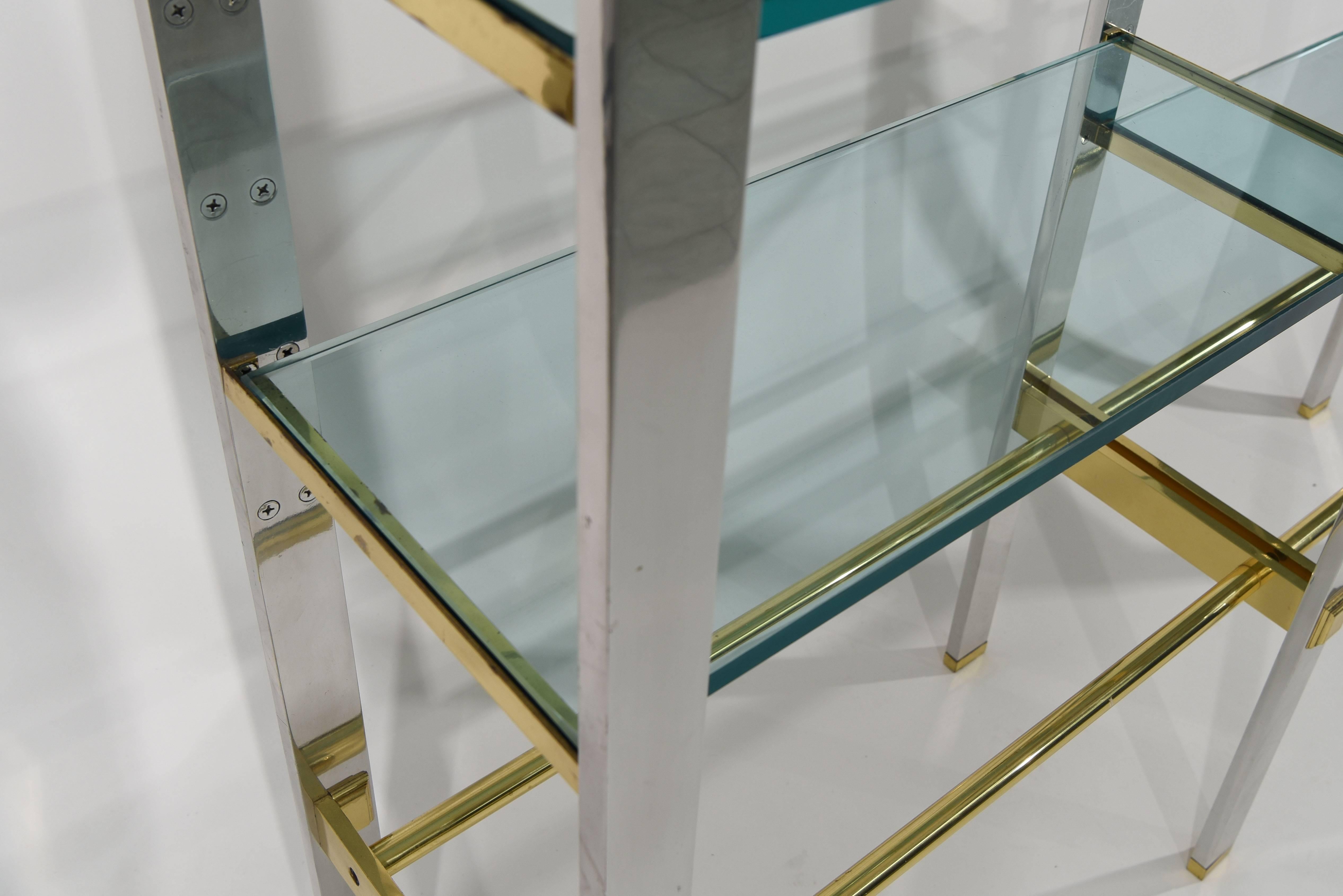 A very substantial chrome and brass etagere with half-inch thick glass shelves.