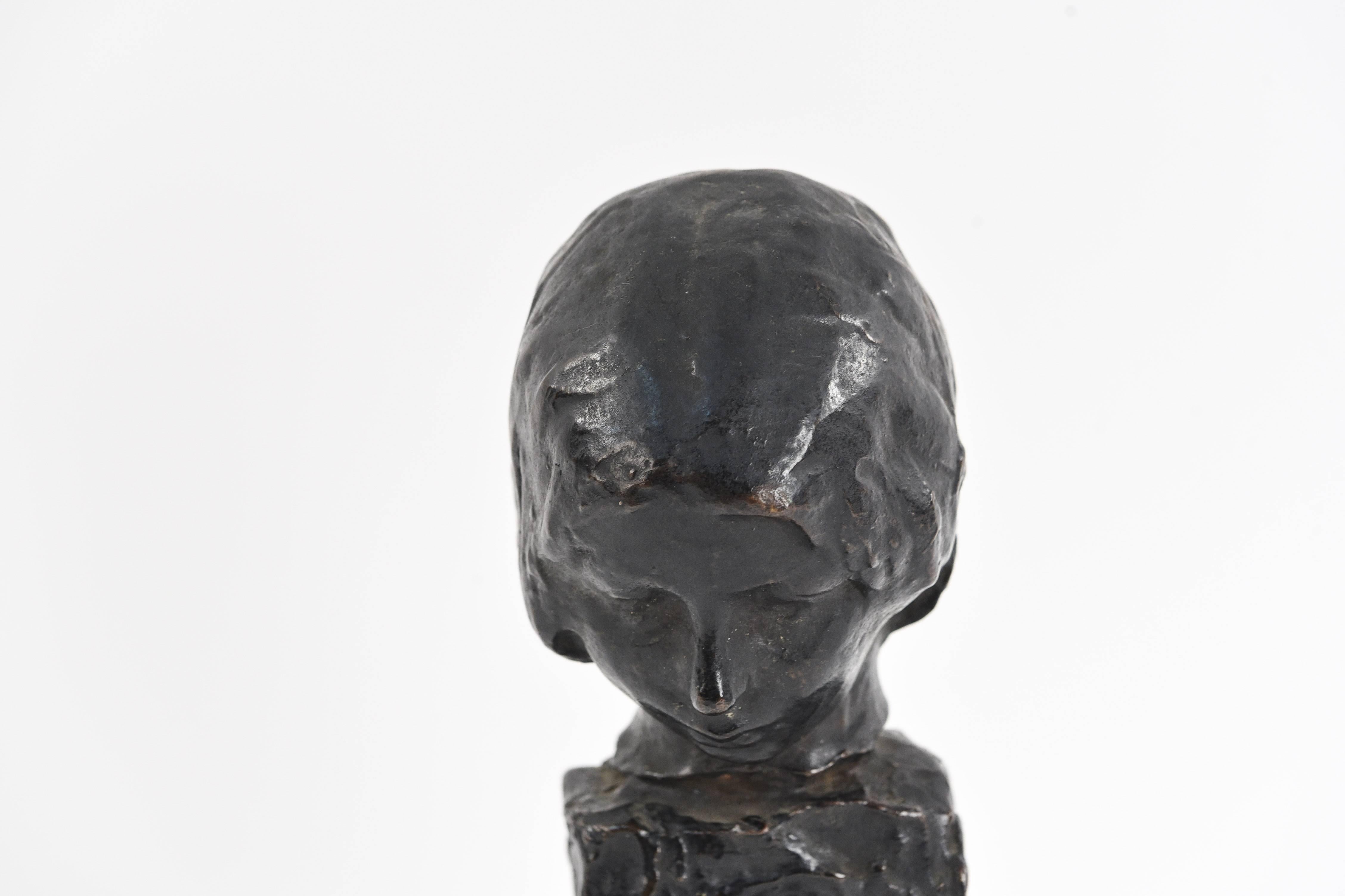 Marked underneath No. 1, and signed George Conlon, German Bronze Works to base. This patinated bronze bust sculpture of a woman features an interesting abstract pedestal base in the brutalist manner, with the woman's head in a slight downturned