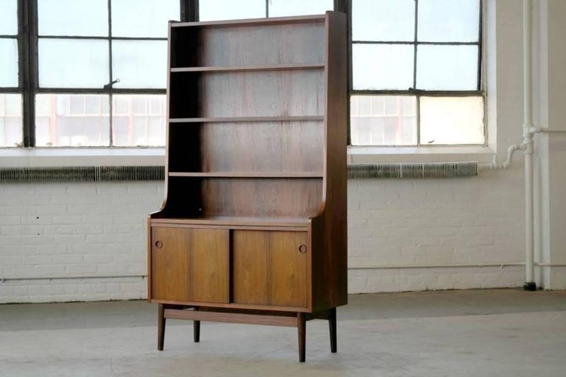 Beautiful rosewood bookcase by Johannes Sorth for Bornholm's Mobler also knows as Nexoe Teak. Very useful with adjustable shelves and two storage cabinets underneath. These bookcases are becoming increasingly sought after as Mr. Sorth's designs keep