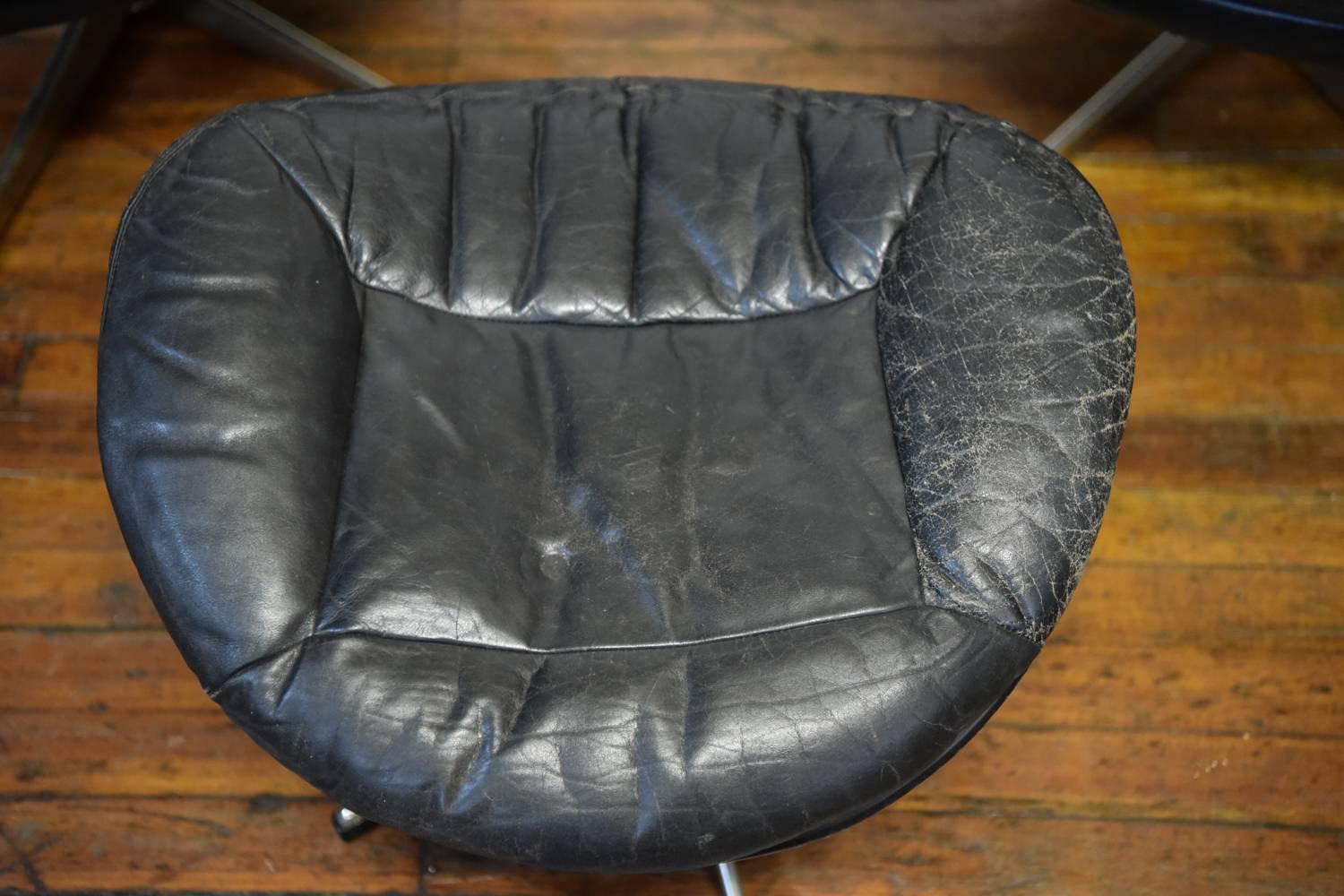 Fantastic pair of high back swivel lounge chairs with one ottoman designed by H.W. Klein for Bramin, Denmark, circa 1970. Upholstered in original rich black tufted leather and mounted on five-star metal swivel base, these chairs are magnificently