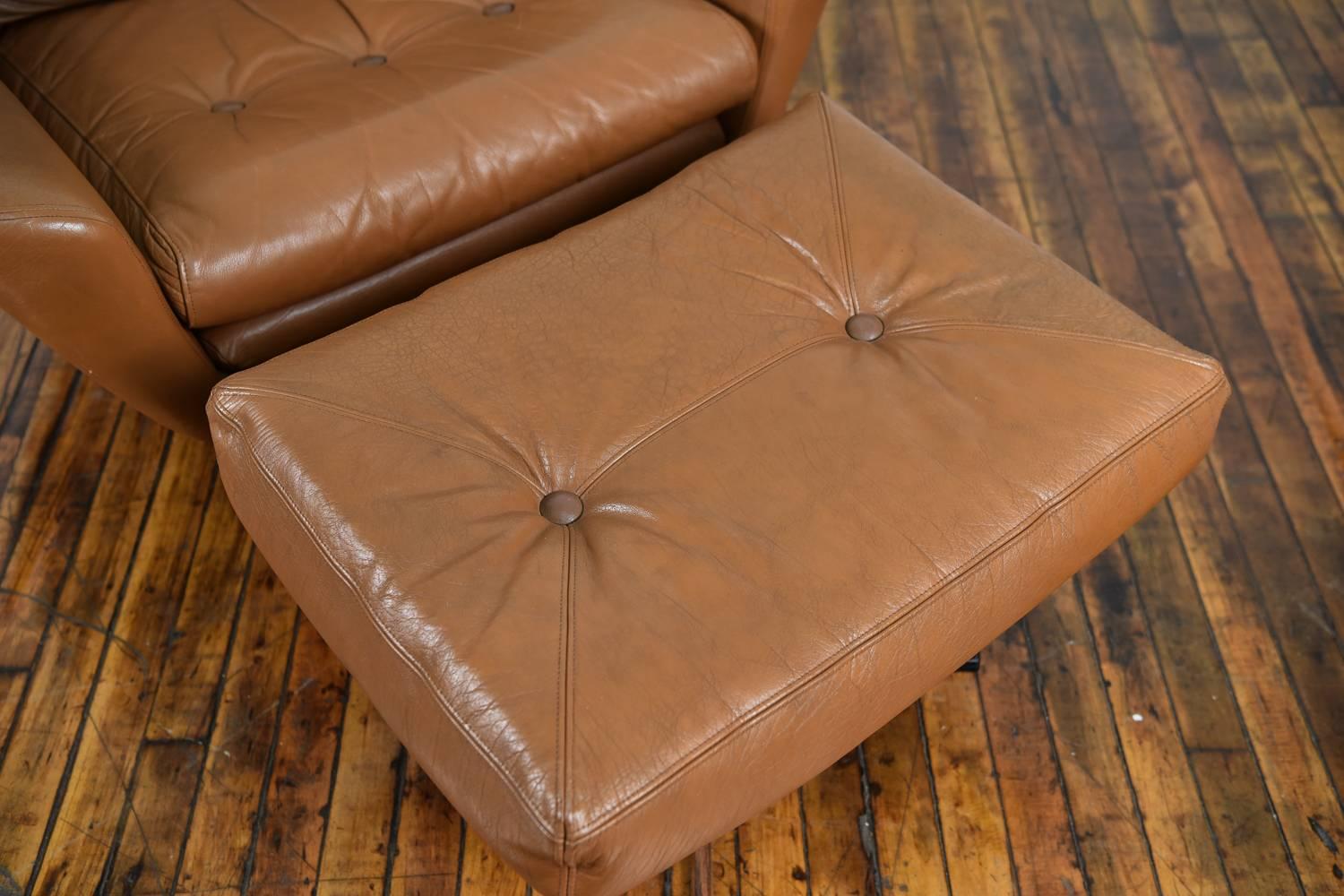 A beautiful Danish Mid-Century brown leather lounge chair and matching ottoman.