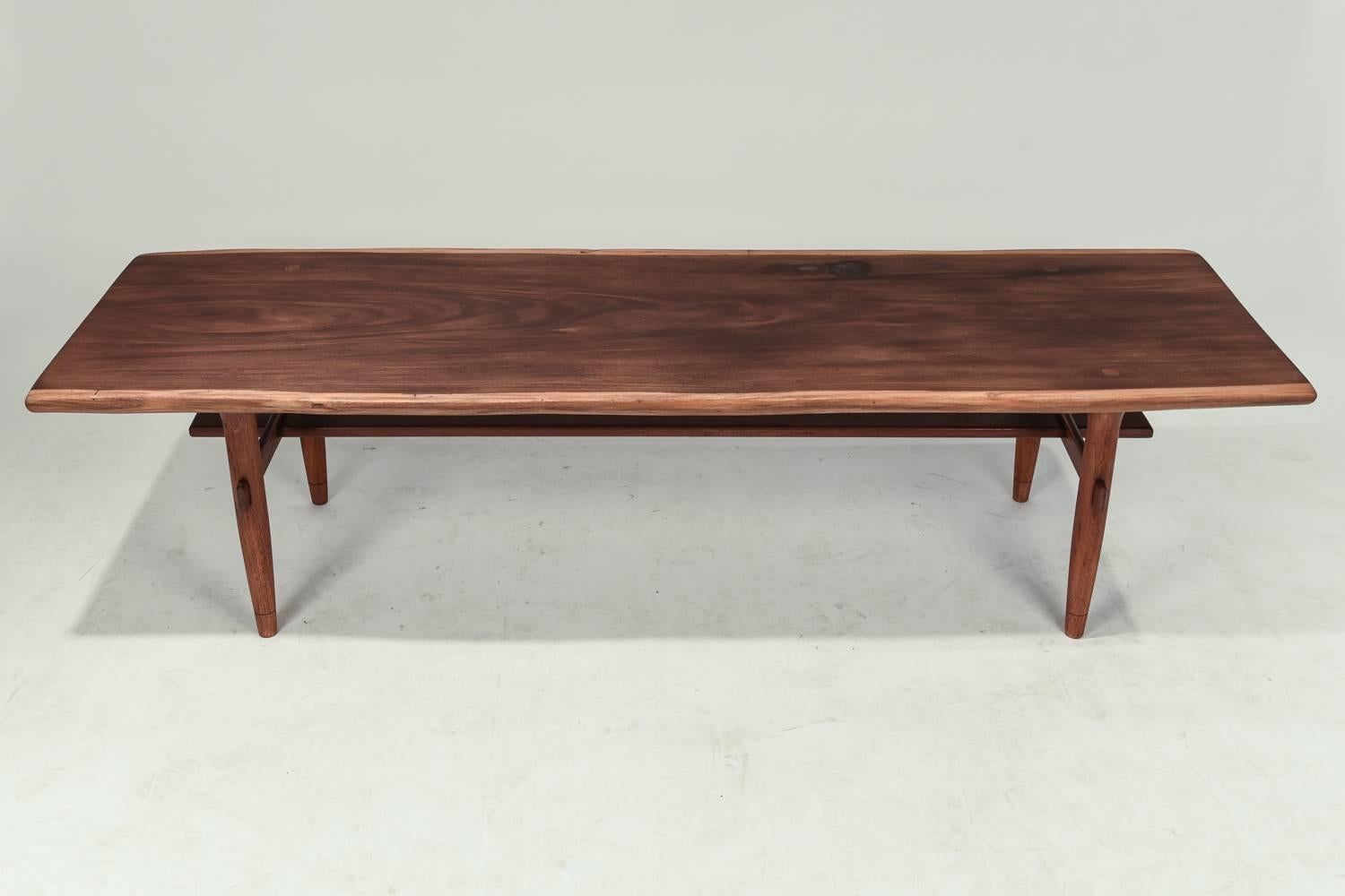 This coffee table by Illums Bolighus features beautiful walnut wood. Has metal maker's plaque.