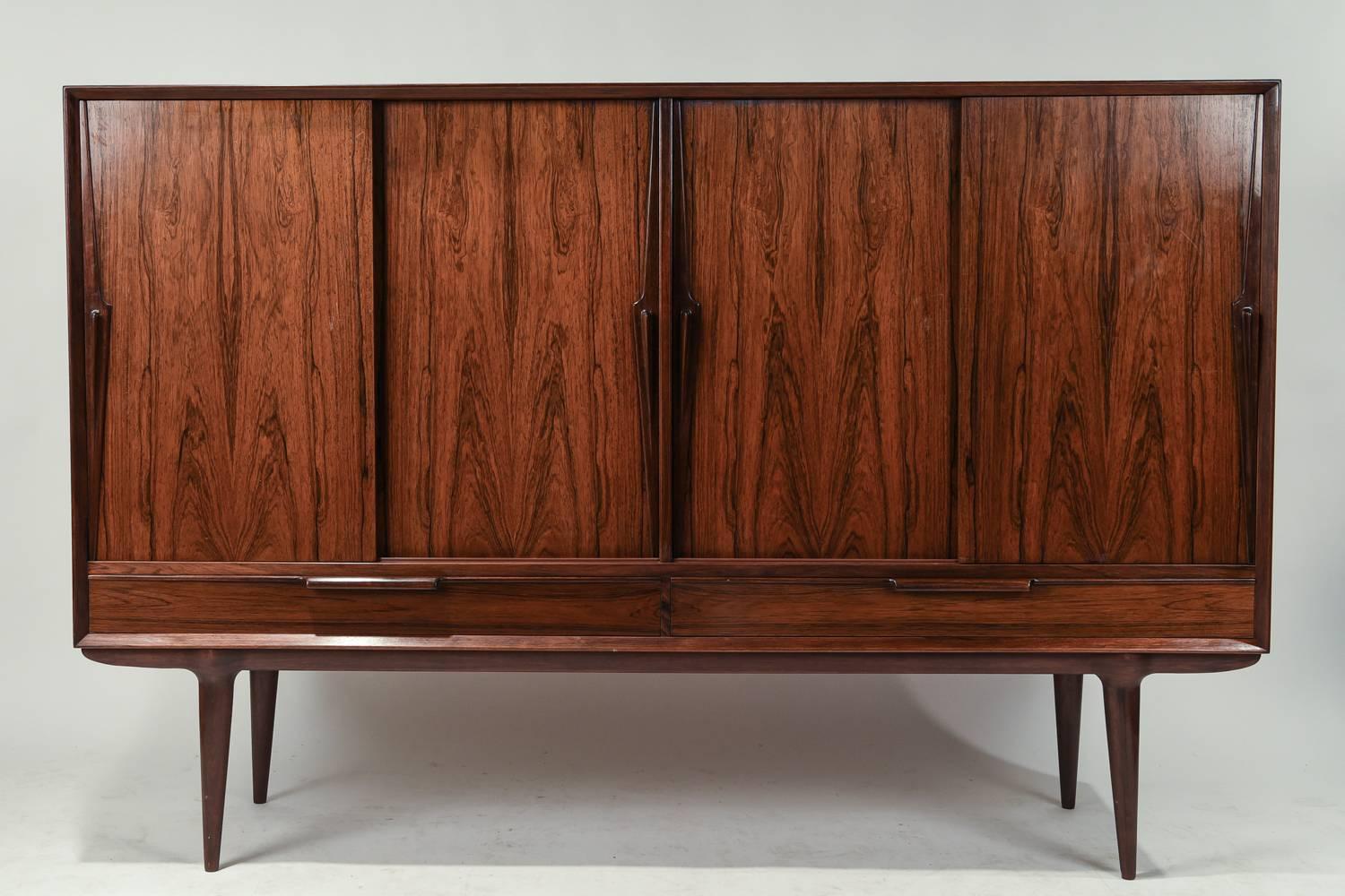 This Danish Mid-Century Model 13 sideboard was designed in the 1960s by Gunni Omann for Gunni Omann Jr. It is crafted of rosewood.