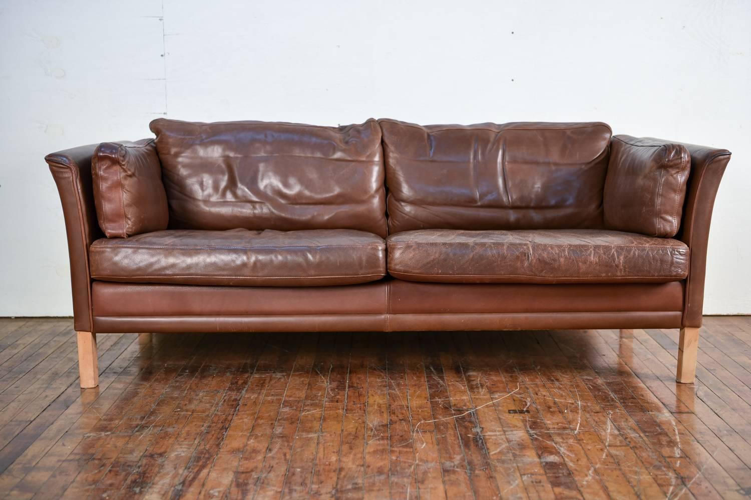 A two-seat sofa or loveseat designed by Mogens Hansen, model MH2225. Fantastic broken in leather.