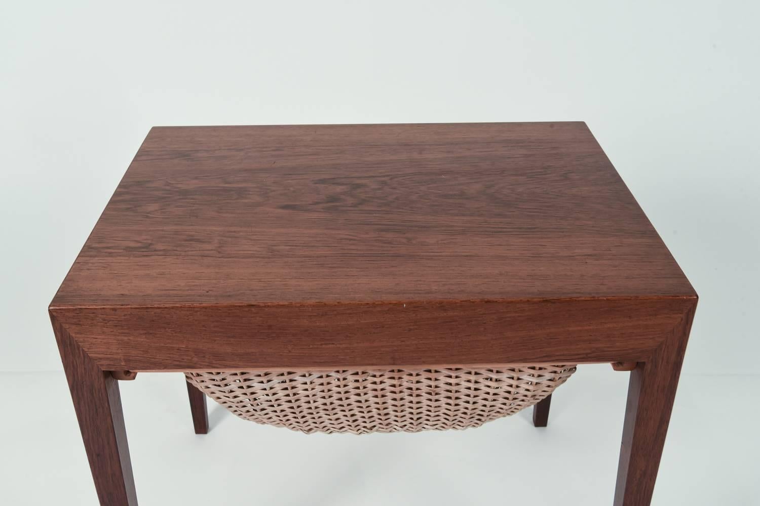 A Danish Mid-Century rosewood sewing table designed by Severin Hansen for Haslev. Features a compartment underneath for storage.