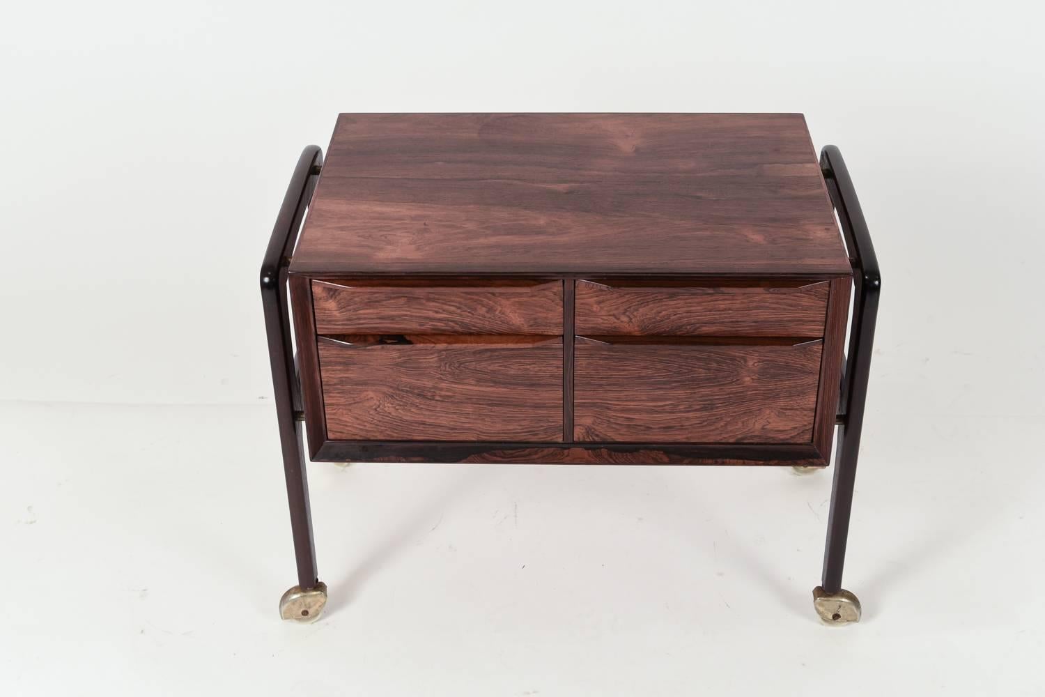 This is an adorable, little Danish Mid-Century rosewood sewing table. On wheels for easy movement.