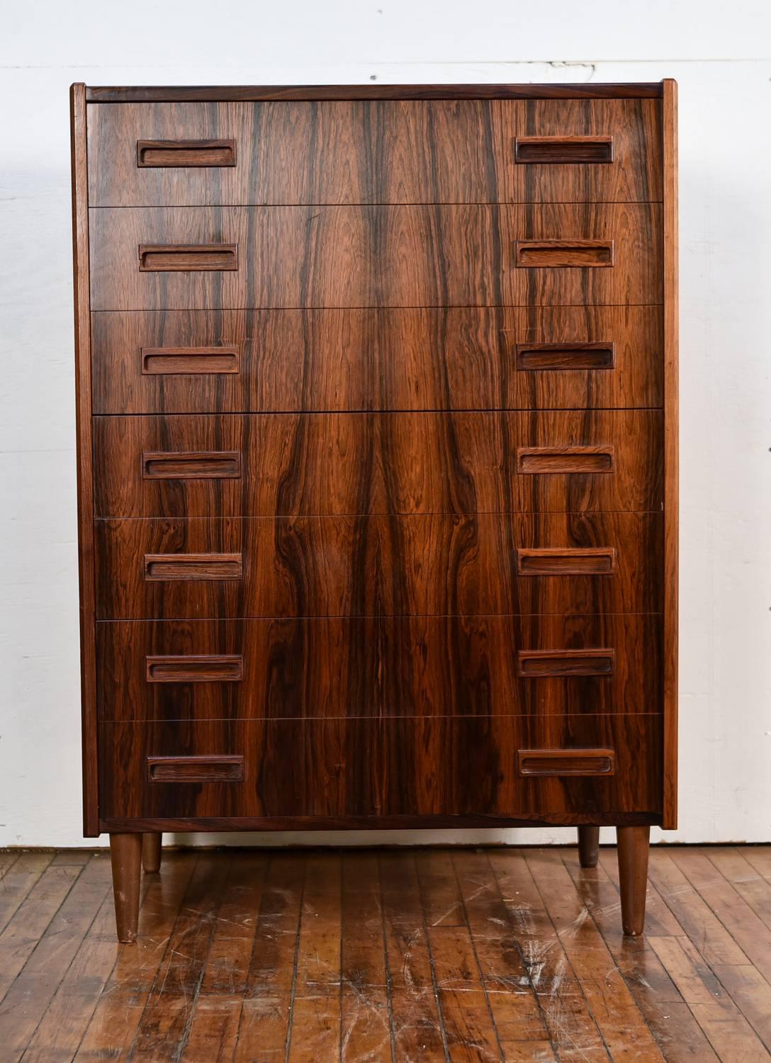 This Danish midcentury rosewood chest has seven drawers for optimal storage. Produced by Westergaard, circa 1960s. Features recessed handles.