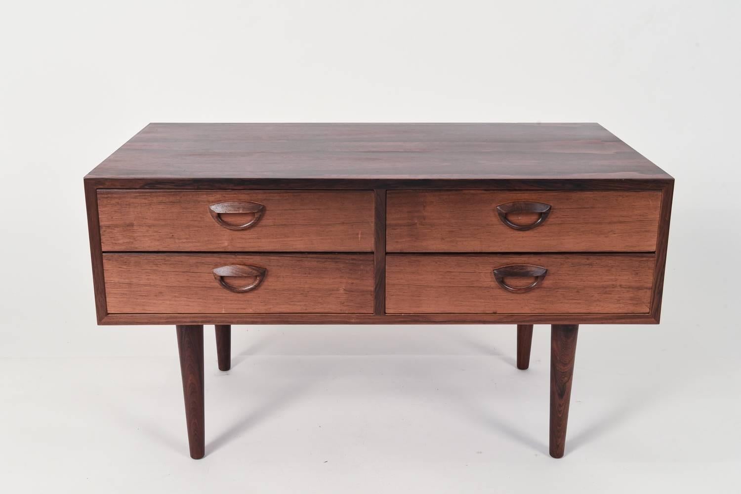 A beautiful small four-drawer chest in rosewood.