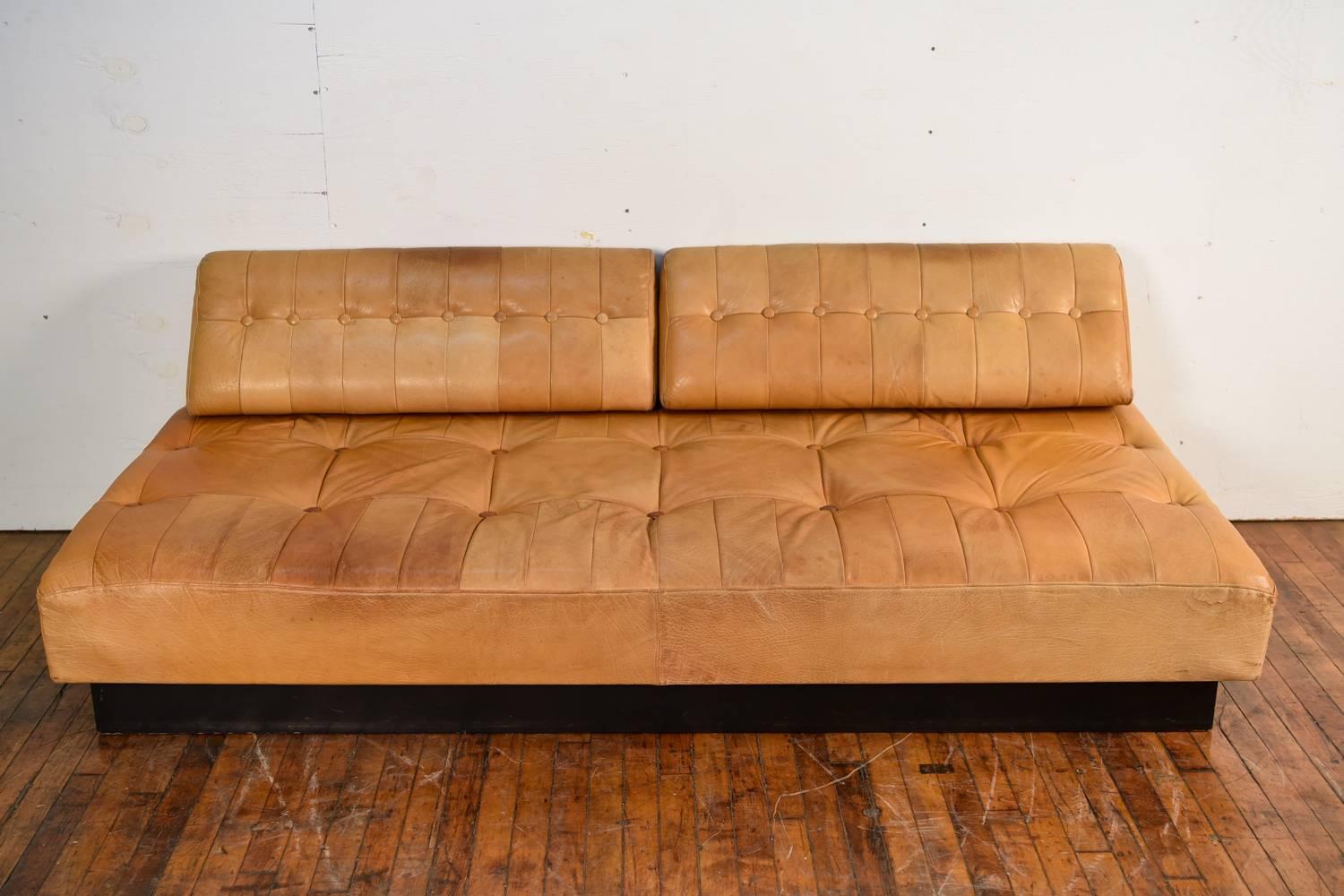 This sofa is in the manner of De Sede's sofa, circa 1985. Wonderful butterscotch colored leather and great tufted detail.