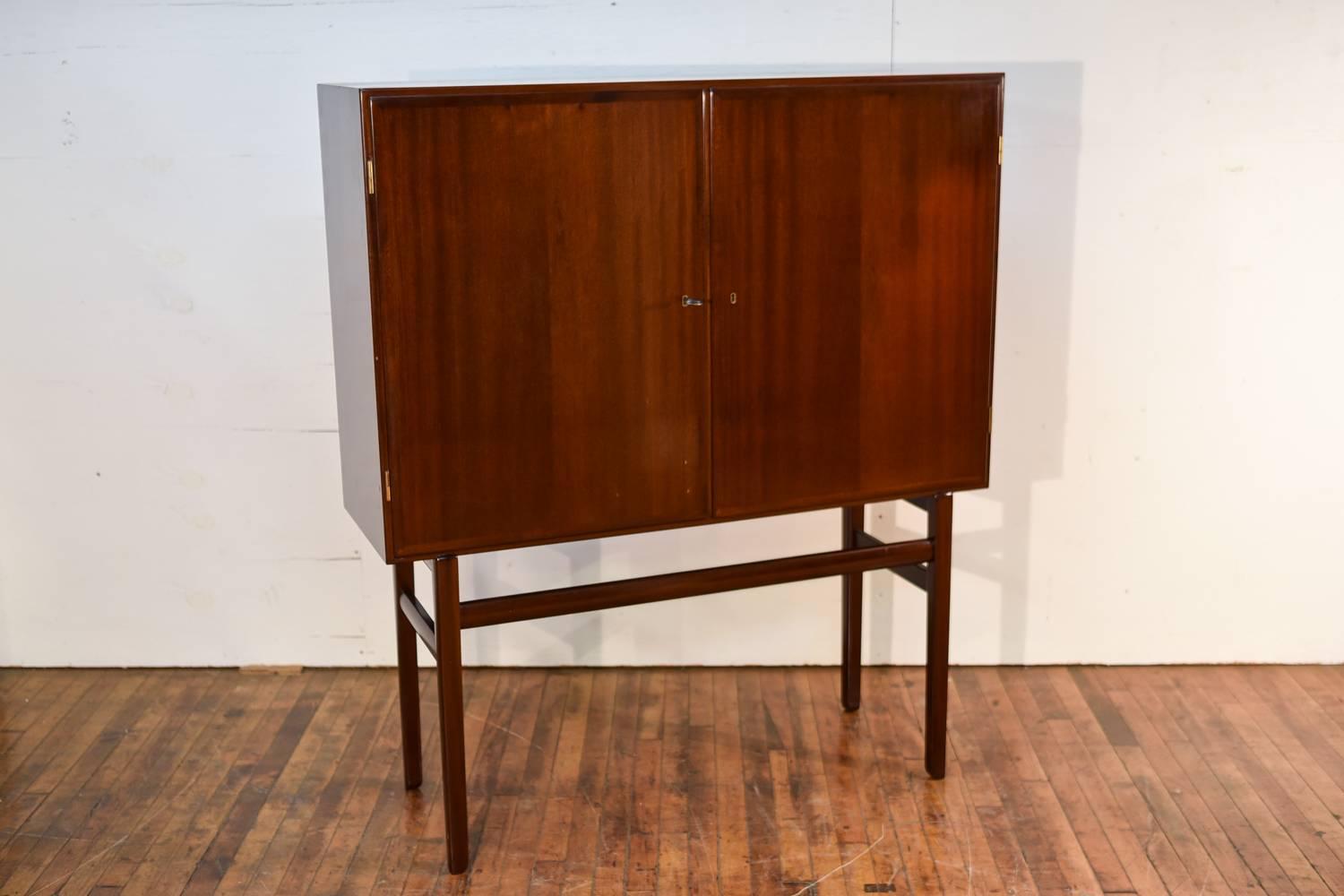 A stunning Danish midcentury mahogany Rungstedlund high cupboard designed by Ole Wanscher was produced during the 1960s and 1970s by Poul Jeppesen Furniture in St Heddinge, Denmark. It was designed for the dining room set called Rungstedlund, named