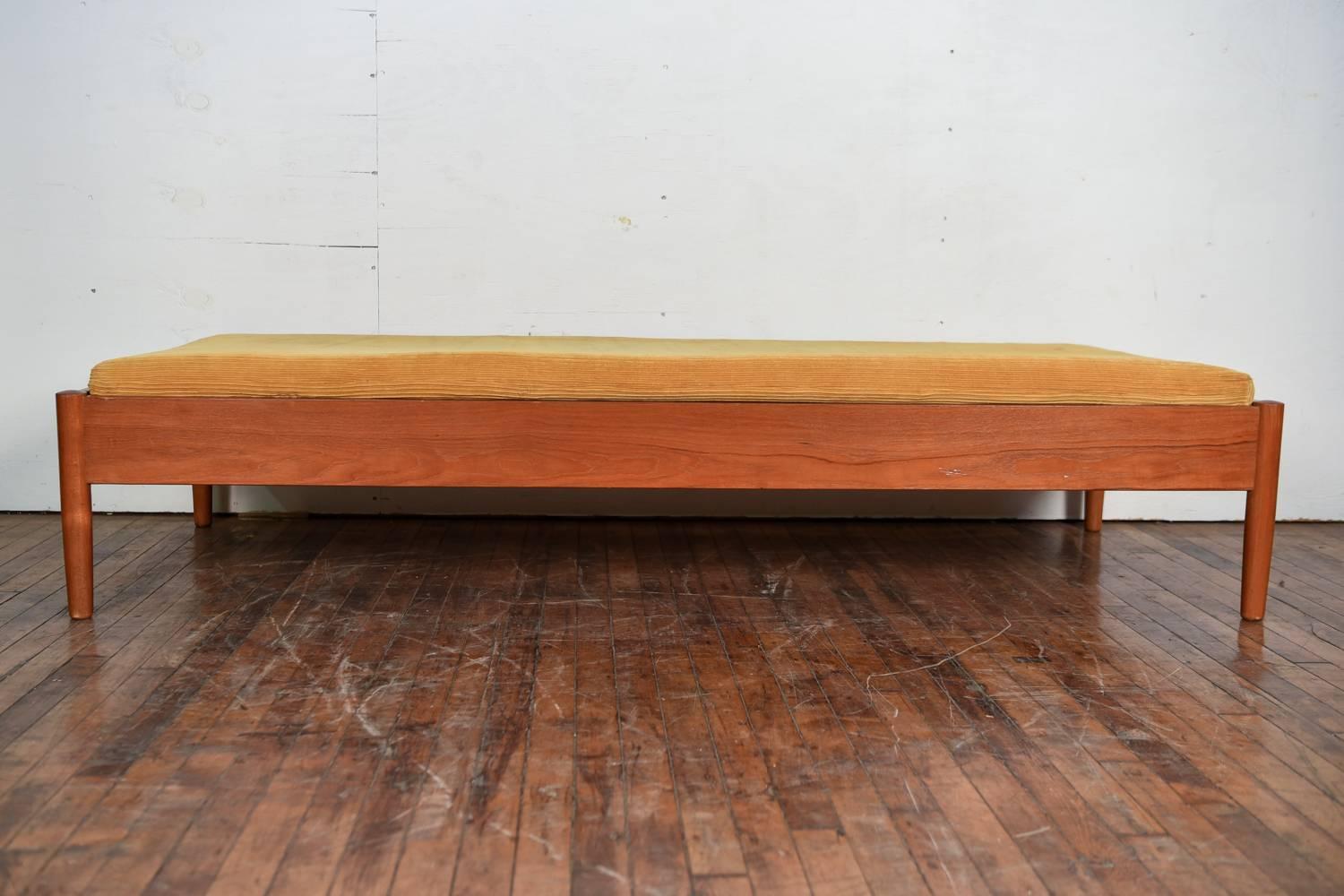 A Danish midcentury daybed with a wonderful teak frame sitting upon rounded legs. This would be a fabulous piece for reclining and relaxing upon. The cushion could be reupholstered in a desired fabric, giving it the potential to be transformed