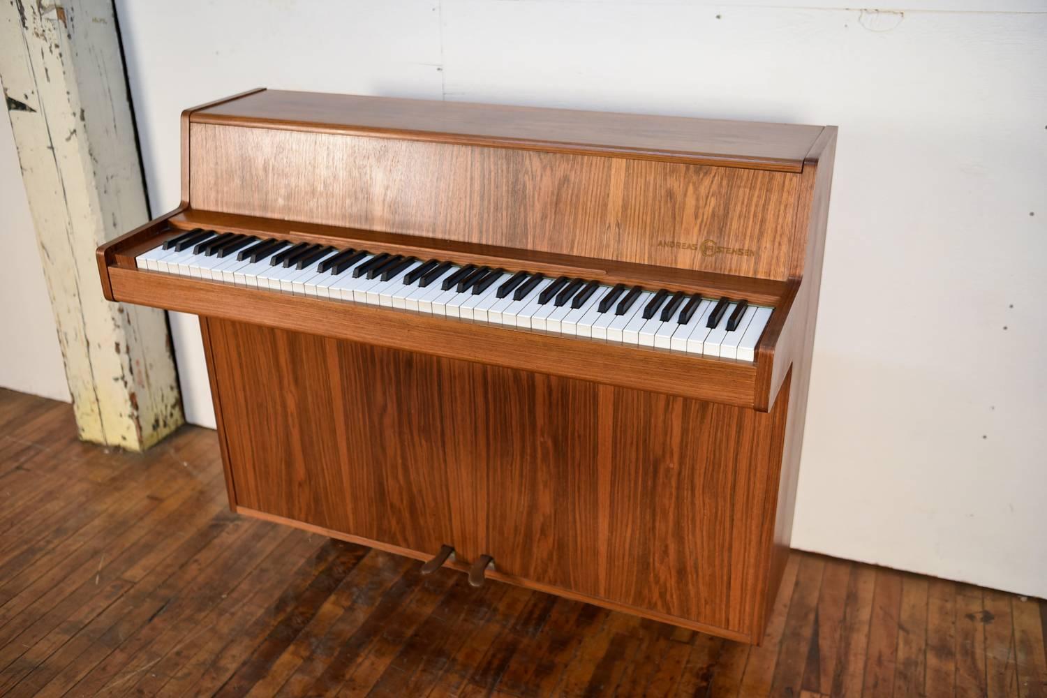 Andreas Christensen is a collectable brand of piano. This Andreas Christensen Picolino upright piano is one of the more simplistic designs they have made. Compact size making it a good fit for tight spaces.