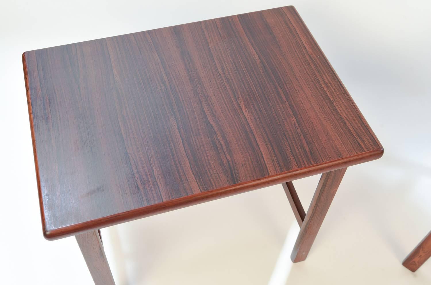 This lovely pair of Danish midcentury side tables feature handsome rosewood with exquisite color and grain. A wonderful, simple design that gives a handsome appearance.