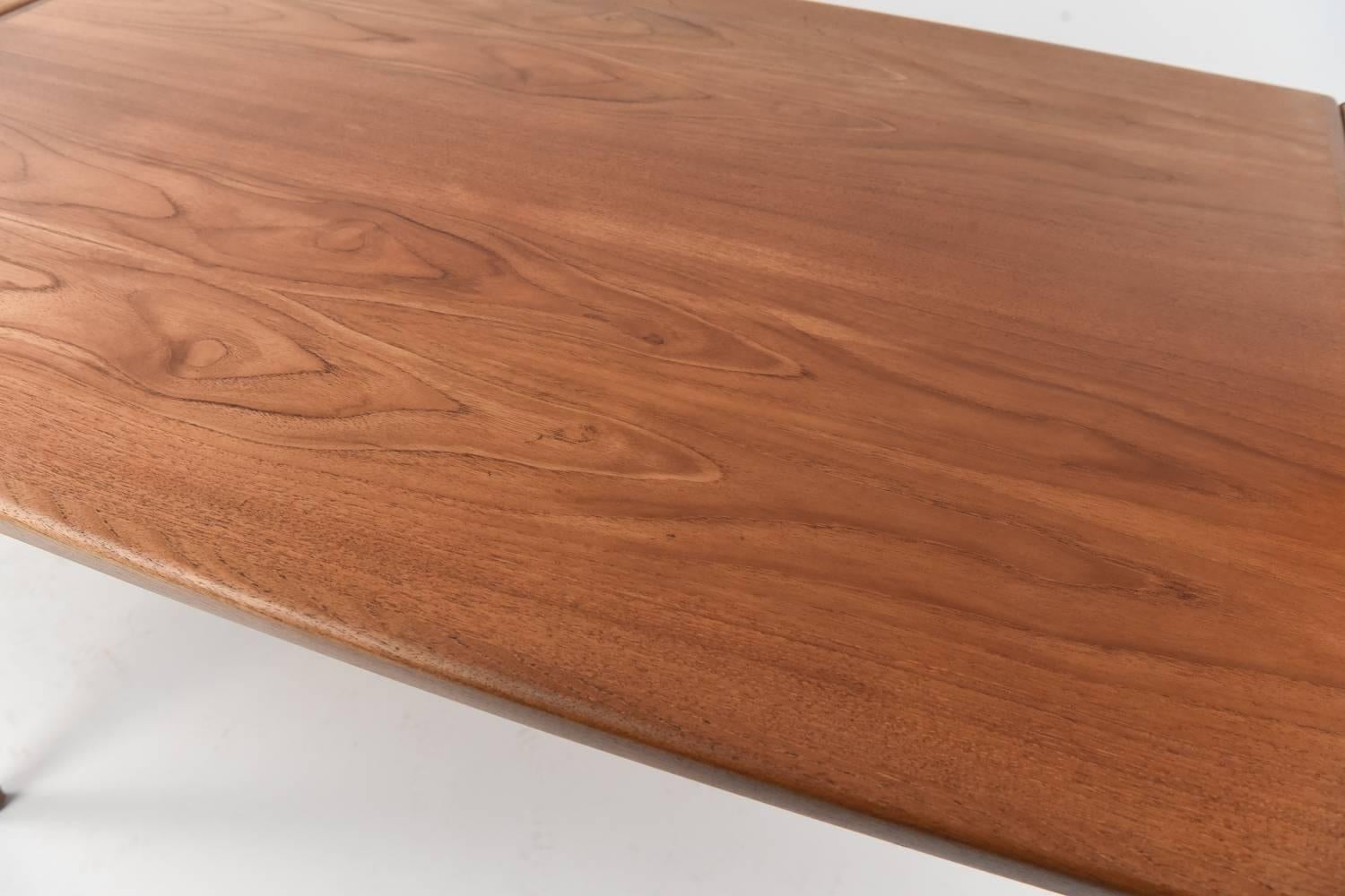 A fabulous teak table to entertain guests around! A perfectly simple, Danish midcentury touch to add to any dining room. The table with both leaves extended opens to 86.5" wide.