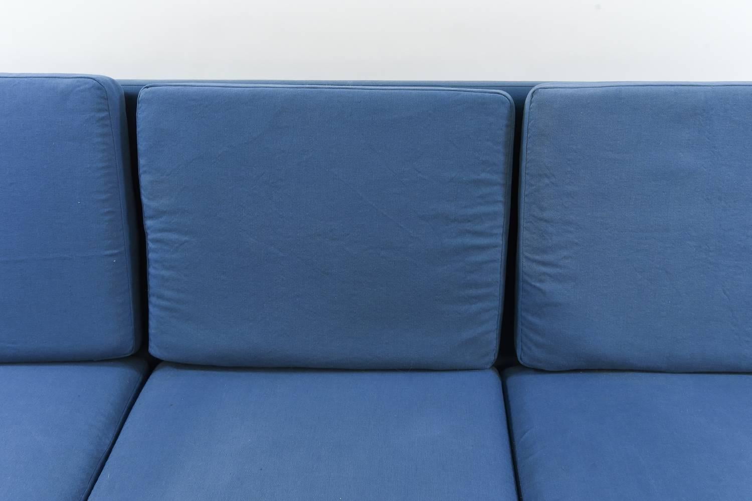 This eye-catching Danish midcentury sofa features a great rosewood frame and is upholstered in striking blue cotton. This would be a perfect pop of color to brighten up a living space!