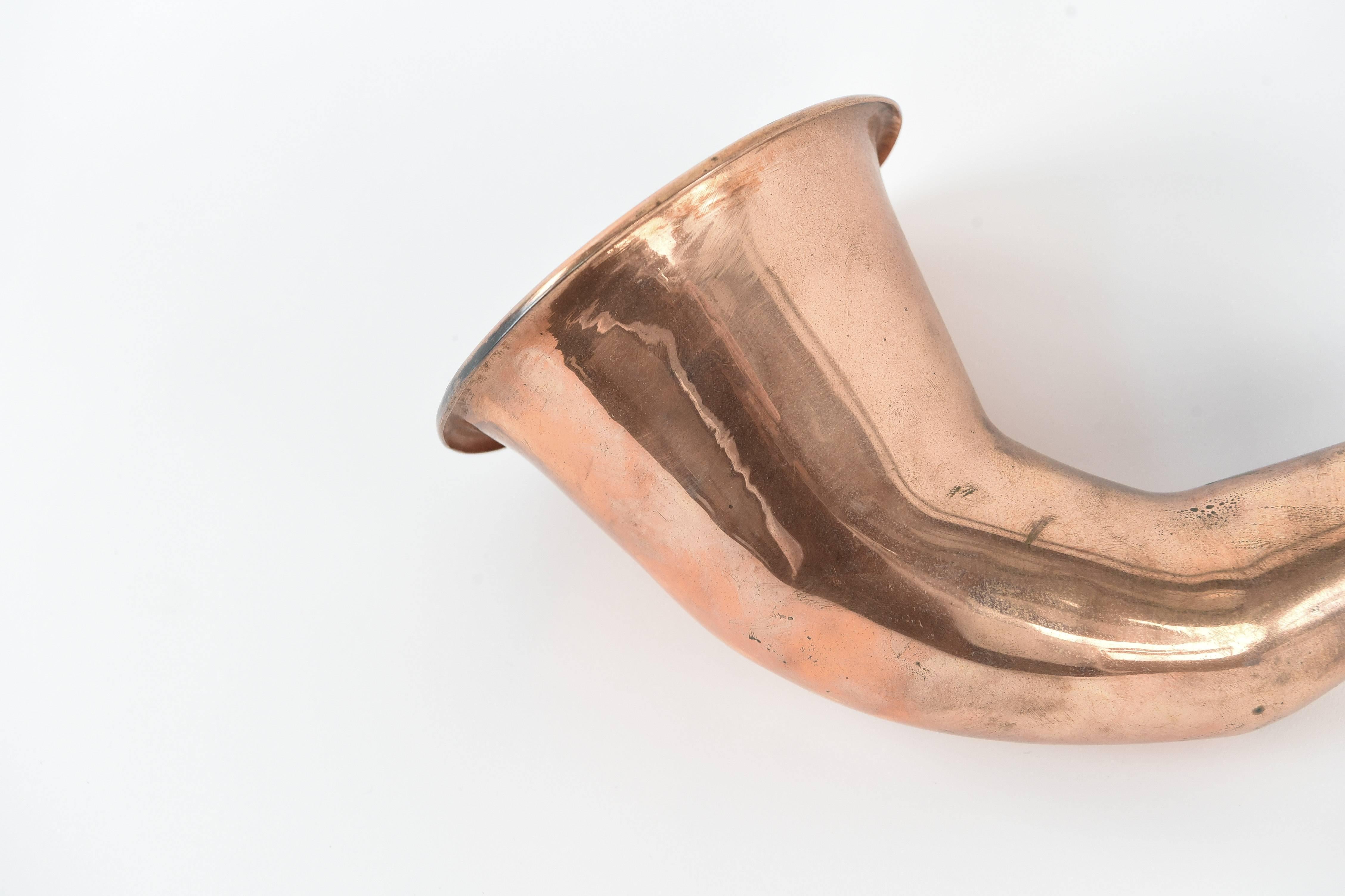 A neat polished copper curiosity, what was once a widely used type of hearing aide is now replaced with modern electronic amplification.