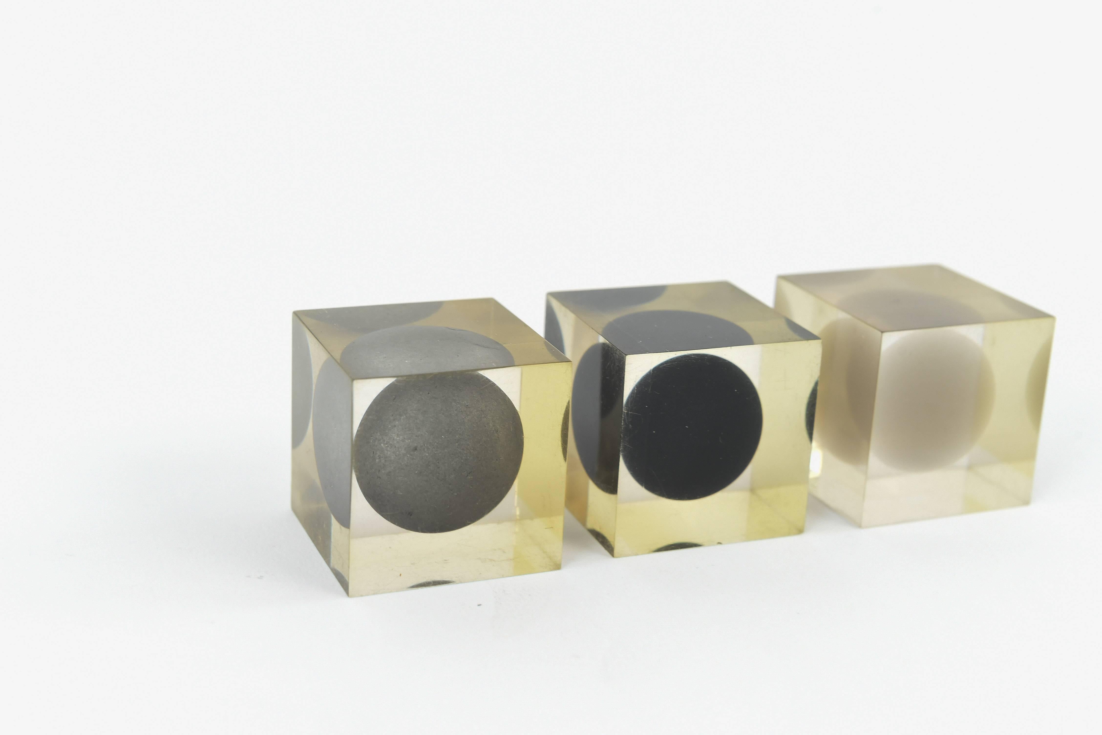 A wonderful selection of three Lucite cube sculptures with encased metal and other spheres.