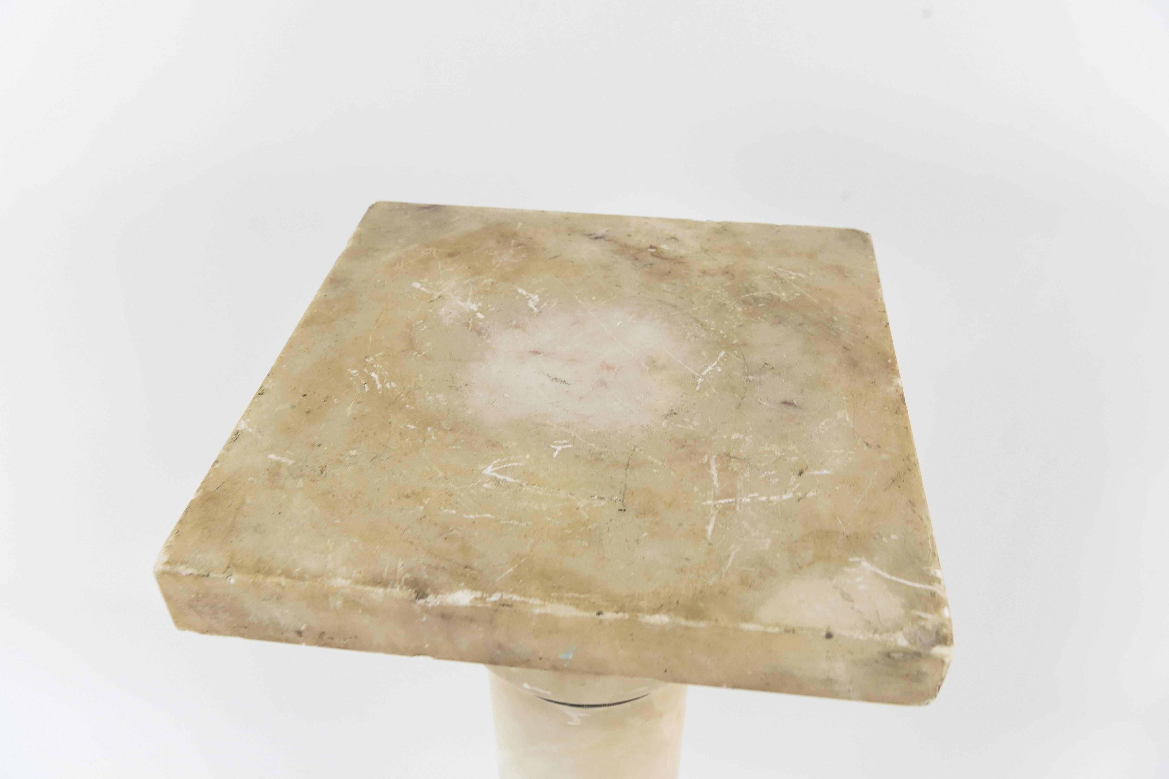 This stunning marble pedestal has a great look on its own, but could also be a beautiful display for another piece. With a neutral marble color, this pedestal would work in any context.