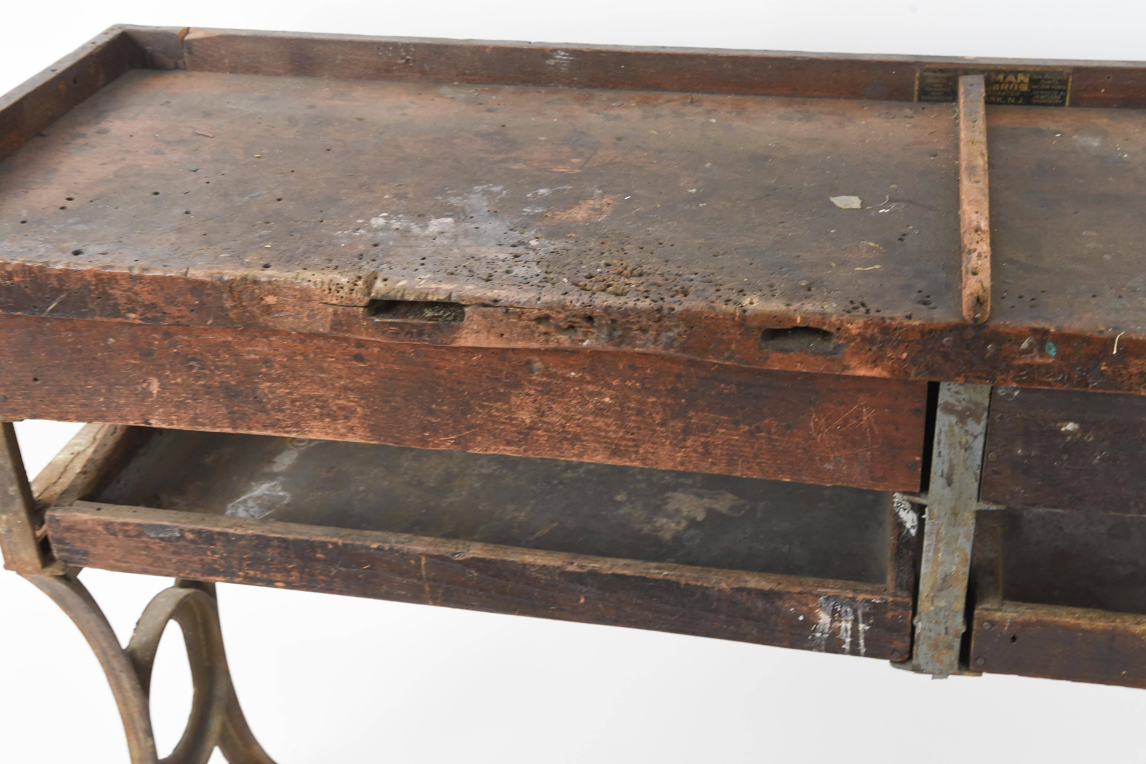A wonderful designed piece of American Industrial history, this awesome bench with great patina was from a jewelers workroom and would make a wonderful console table in any room.