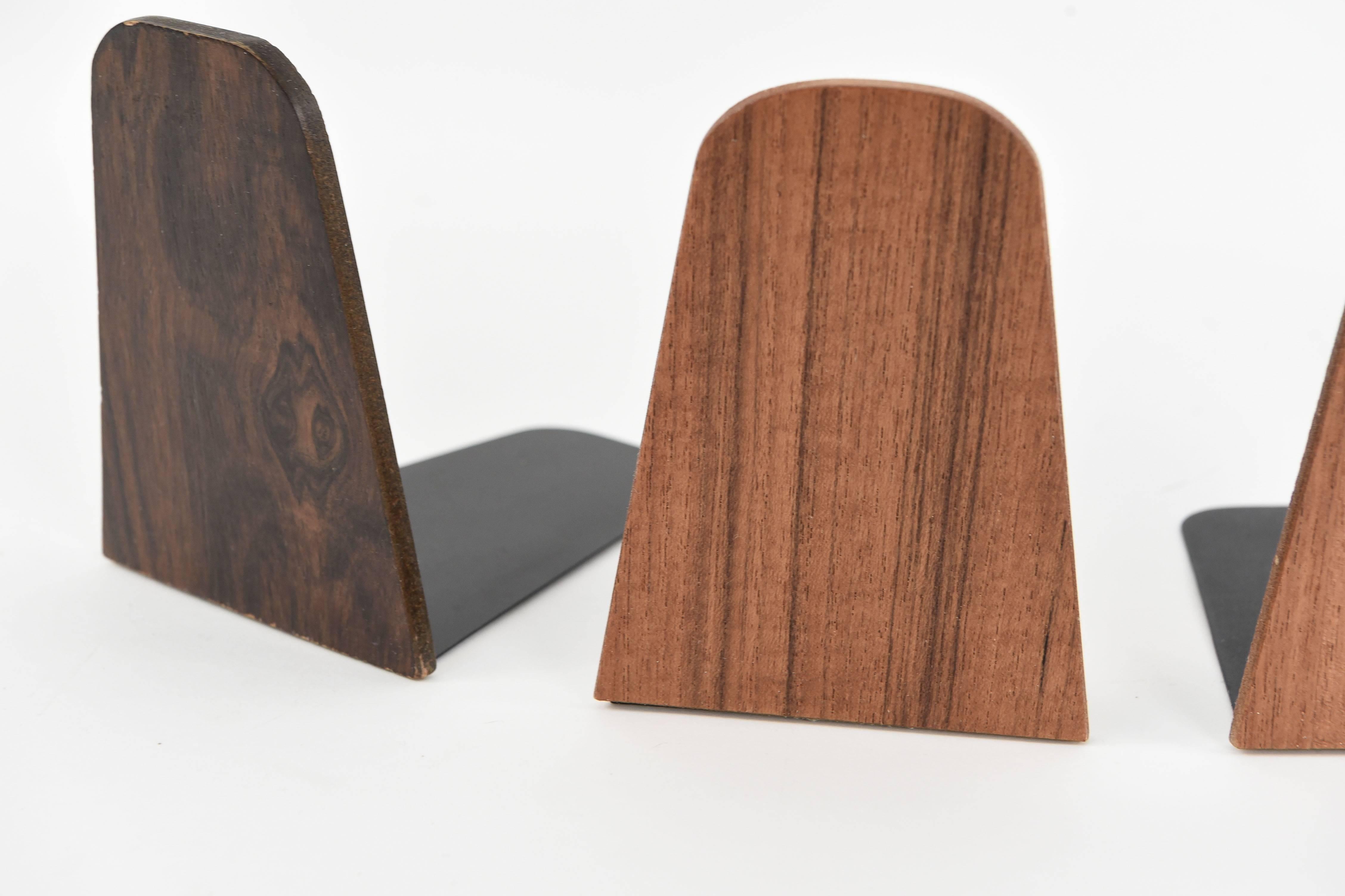 Four beautiful teak bookends in two different shades. These bookends would make a wonderful addition to any bookcase, with great support plus a slim design.