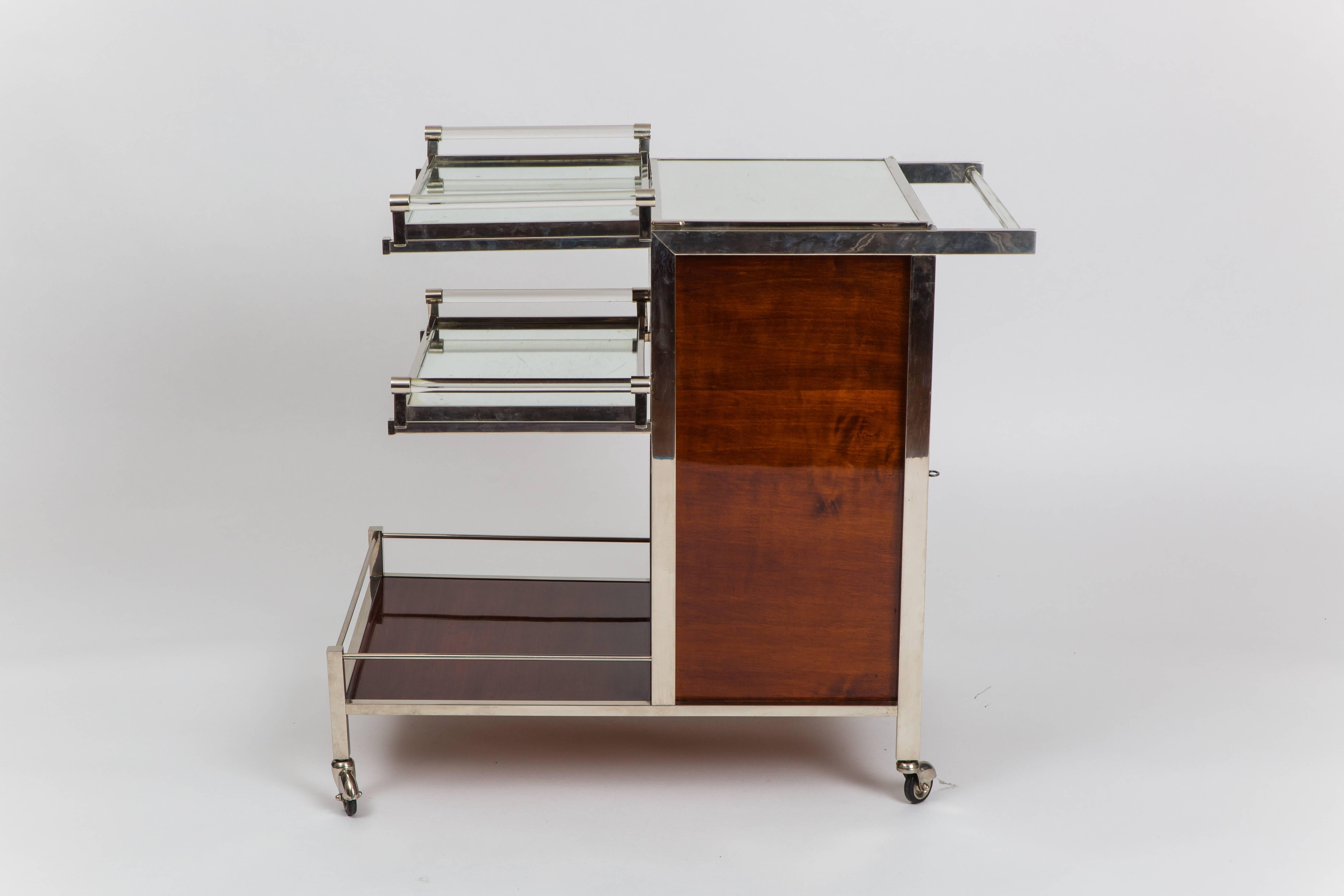 Jacques Adnet Art Deco palisander and chrome-plated metal bar cart with mirrored glass top which flips open to reveal compartment inside, side doors which hold cabinet storage for glasses and bottles, and 2 removable mirrored glass top trays with