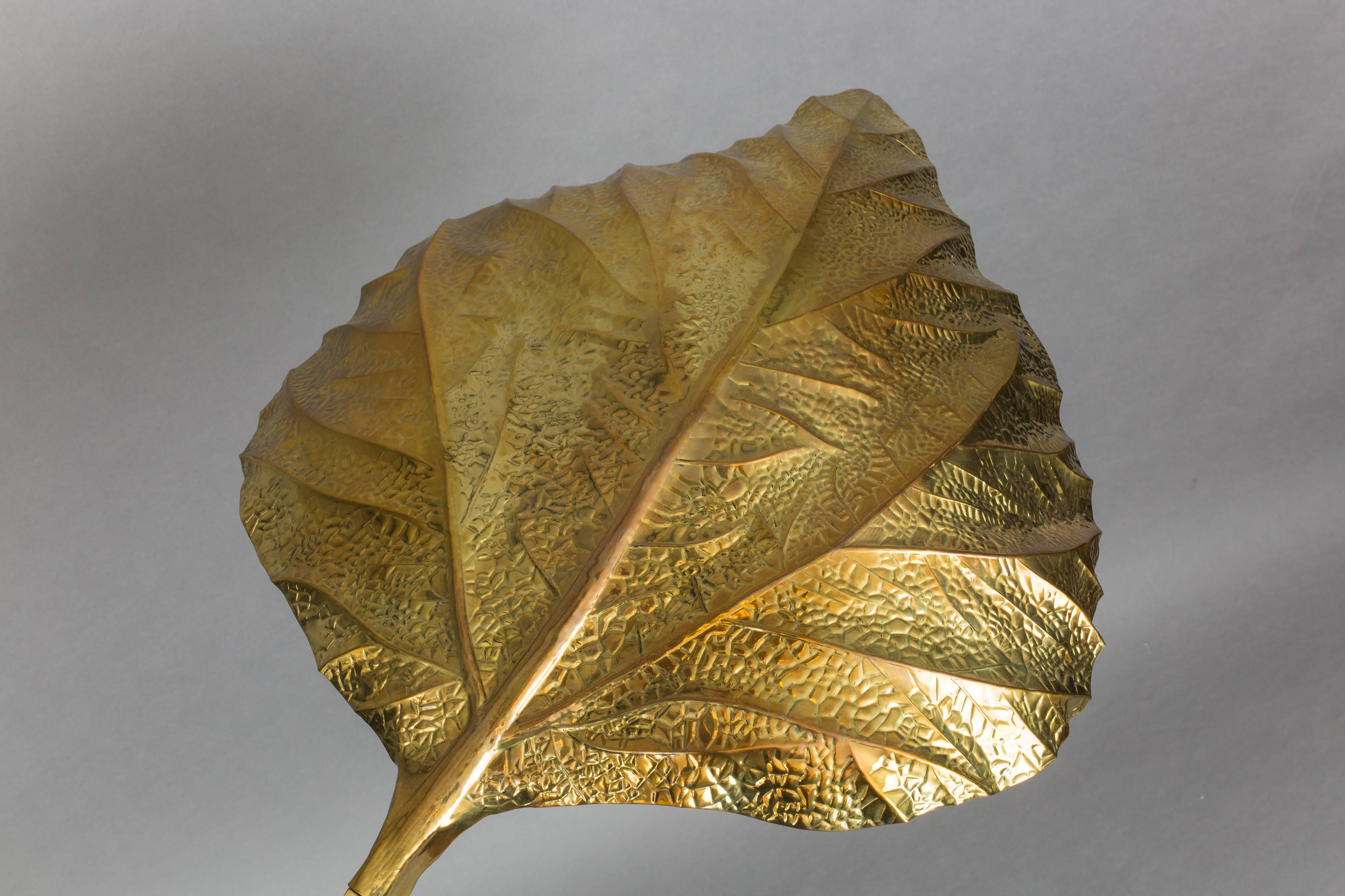 Huge and elegant three-leaf patinated brass rhubarb floor lamps with embossed leaves, handmade using repoussé and chasing techniques, mounted on stems ending on circular base. Rewired to U.S. standards.

