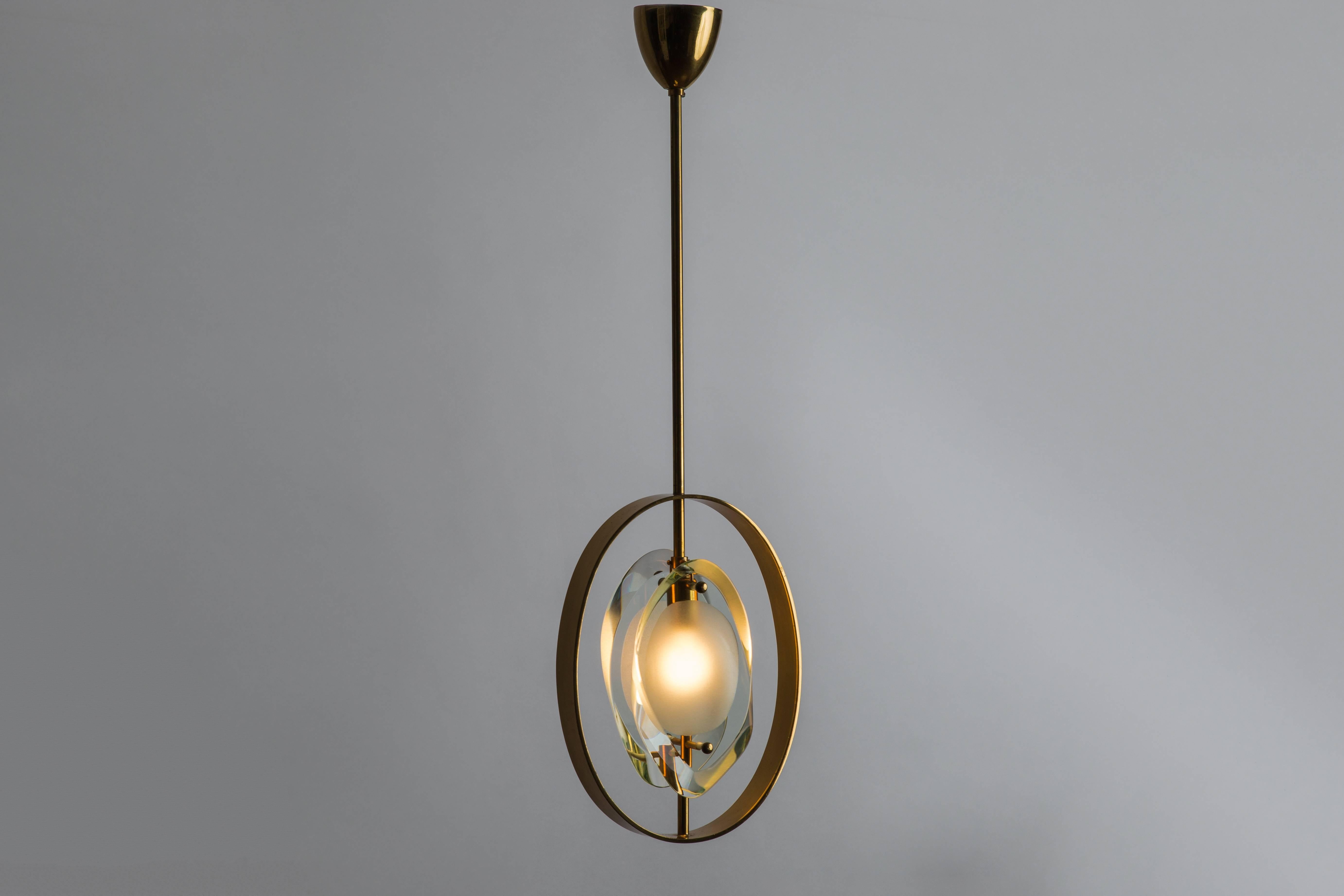 Max Ingrand for Fontana Arte pendant ceiling light composed of double lens-cut plates of thick profiled polished glass with frosted glass centers suspended from brass structure and canopy, Italy, circa 1961. 
In excellent original condition and