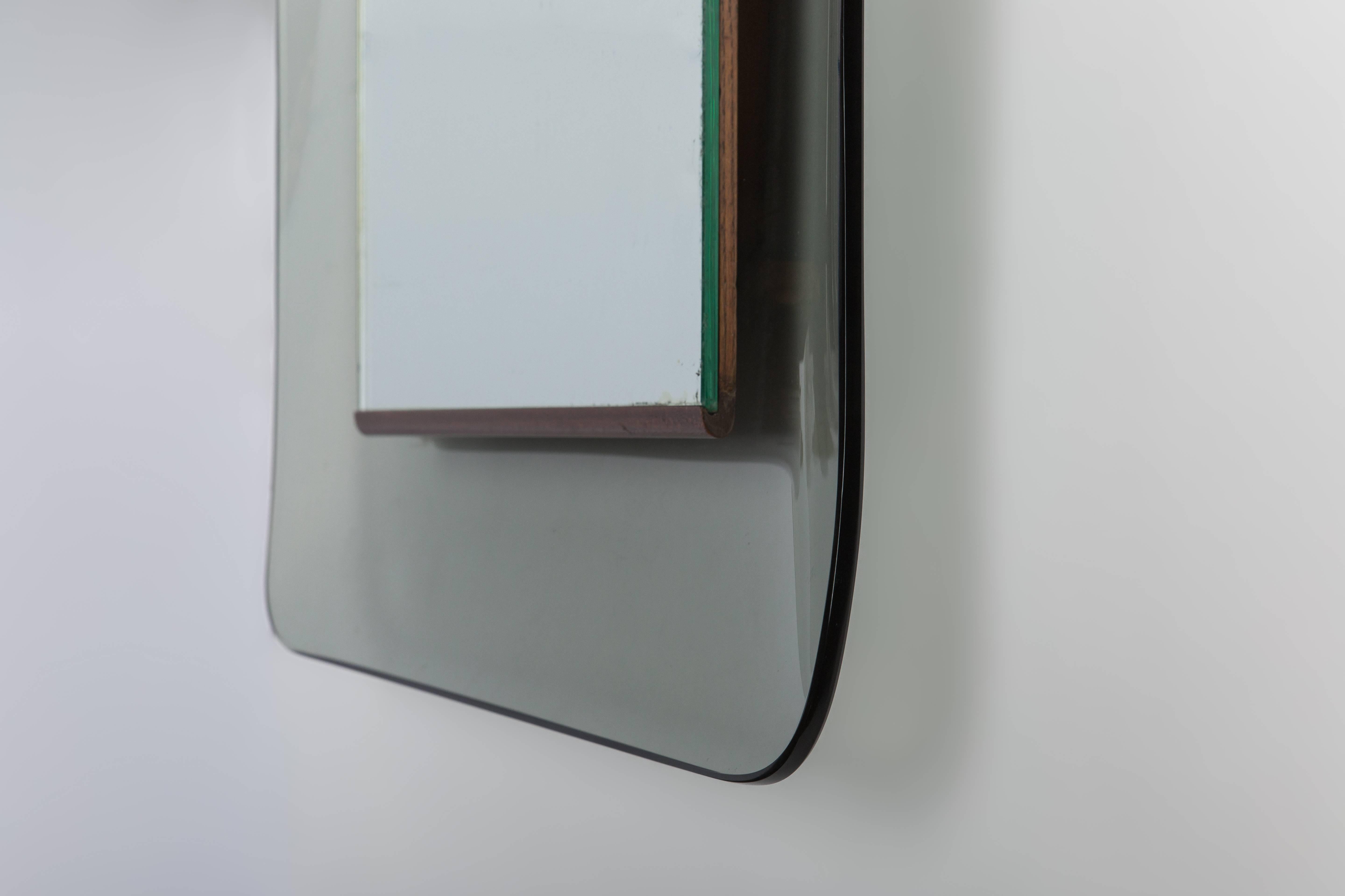 Max Ingrand for Fontana Arte rectangular gray, curved, profiled crystal glass framing mirrored glass with wood details, Italy, circa 1956. Simple in design, but very classic with subtle elegant details.

Literature:
Franco Deboni, Fontana Arte: Gio