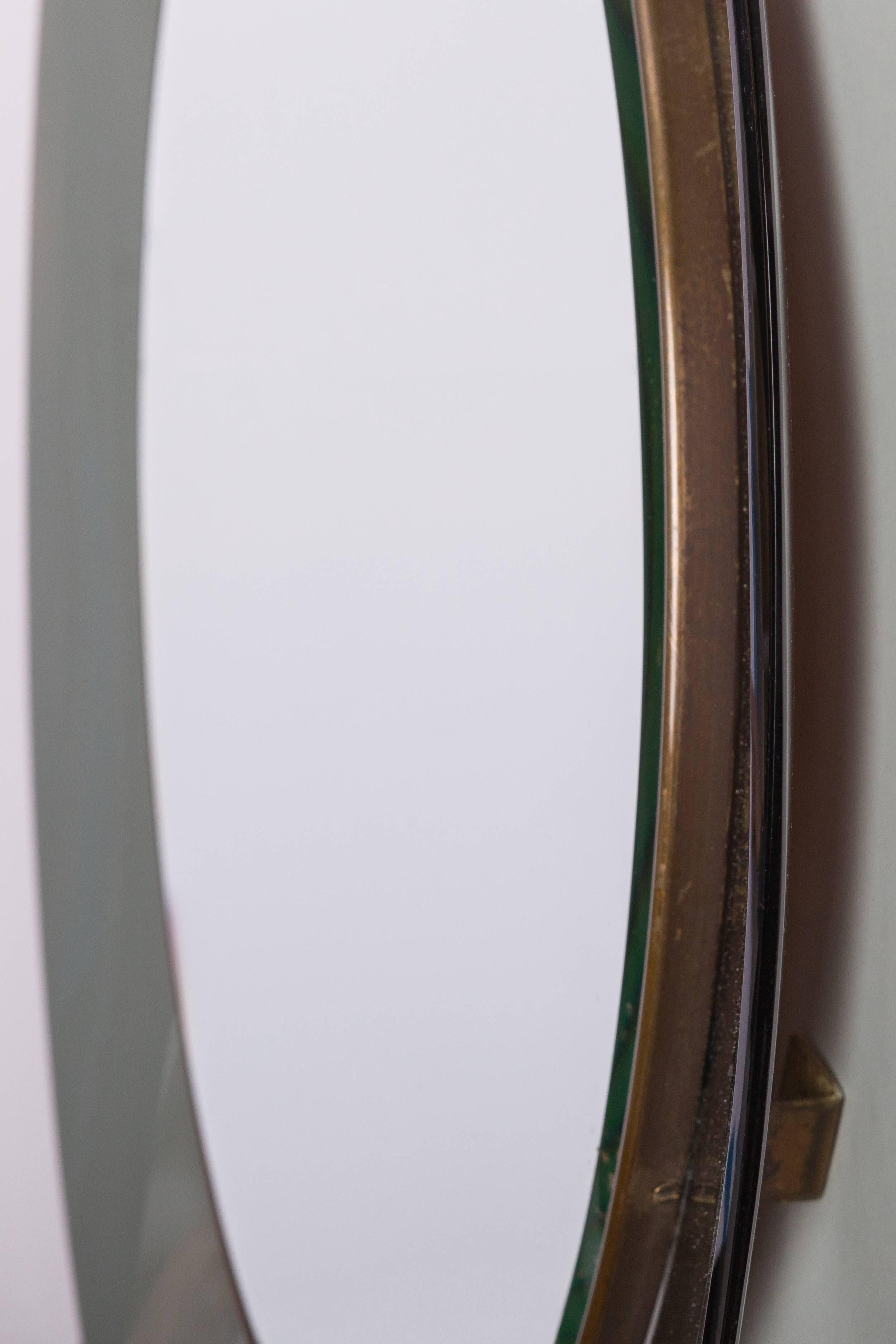 Max Ingrand for Fontana Arte  classic and elegant gray-green colored, curved and beveled glass framing mirrored glass encased in brass trim, Italy, dated on the back '1966.'

Literature:
Quaderni Fontana Arte 2, 1962
Domus, no. 424, March