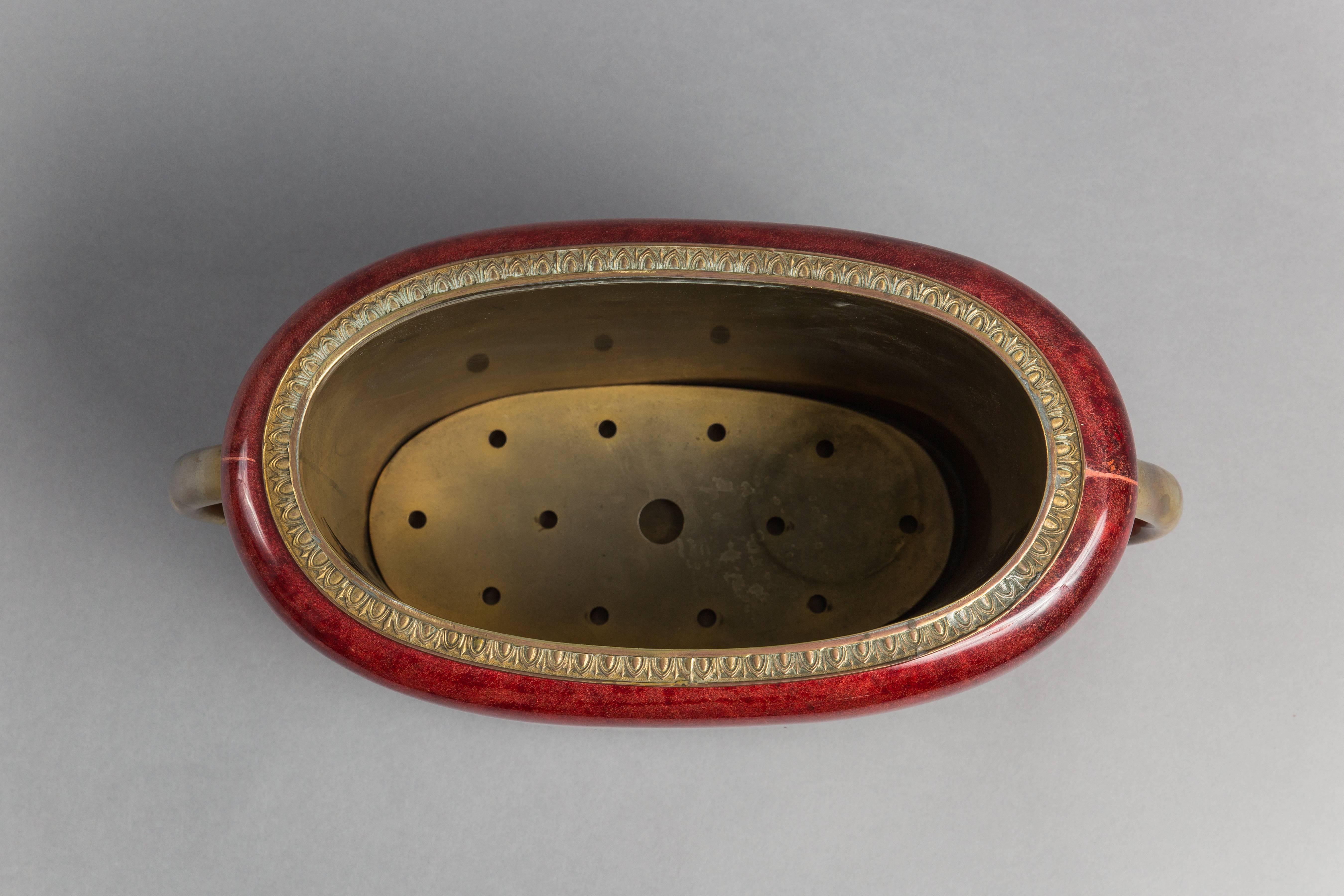 Lacquered goatskin with brass handles and interior comprised of raised pattern design on rim and including removable rack on the bottom. Original manufacturer’s label to underside.

This item can be viewed at 1stdibs Gallery at the New York Design