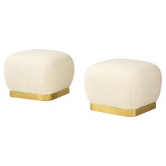 Karl Springer Pair of Souffle Ottomans in Ivory Bouclé and Brass, 1980s