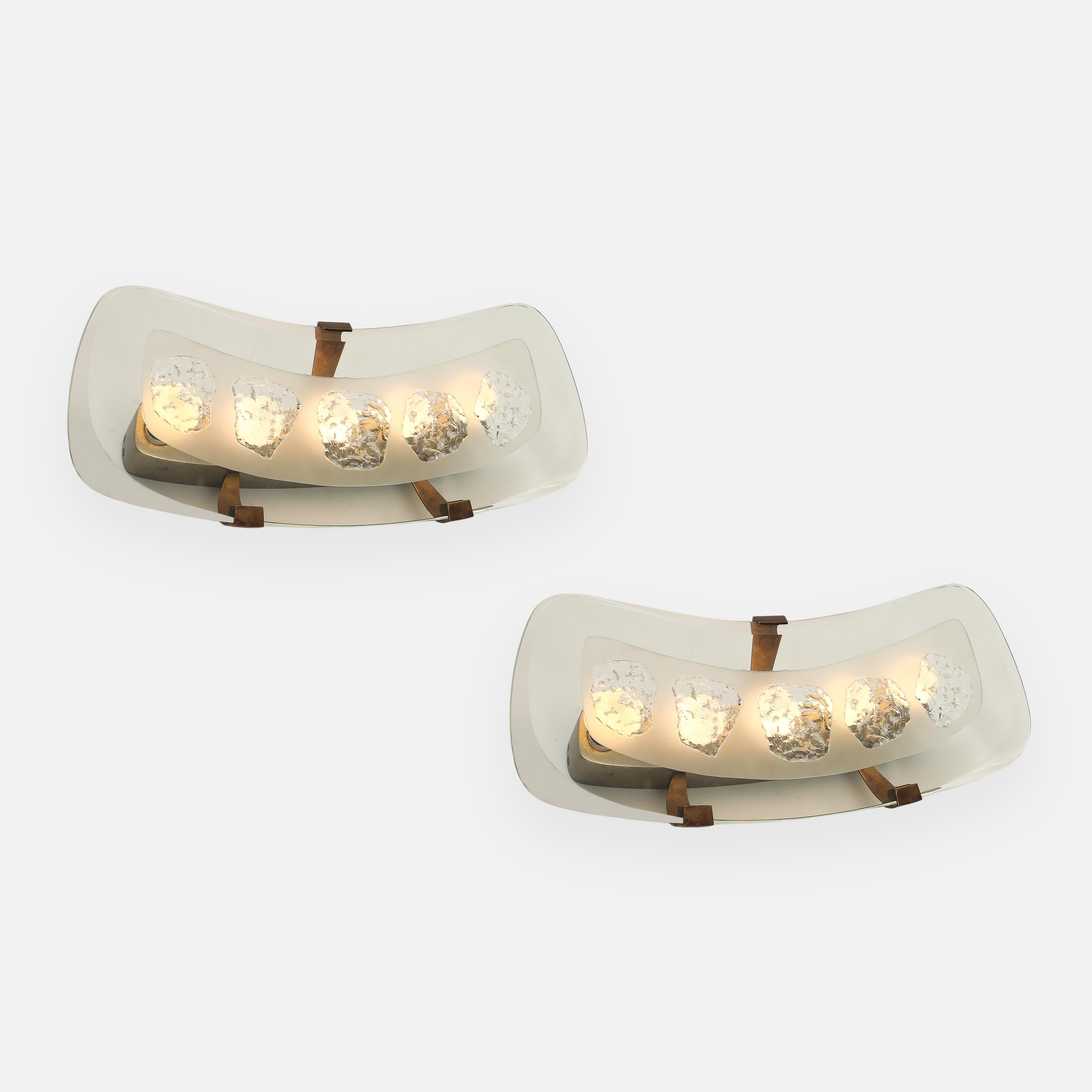 Max Ingrand for Fontana Arte rare and extraordinary pair of large wall lights or sconces model 1598 in thick curved beveled polished glass diffusers with five chiseled-cut glass mid-sections and satin or acid-etched glass surround, mounted with