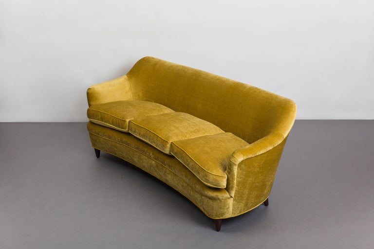 Gio Ponti for Casa E Giardino elegant slightly curved sofa with Italian walnut legs, Italy, circa 1938. Fully restored and newly upholstered in light gold antiqued velvet upholstery with new down cushions. 
Sold with 