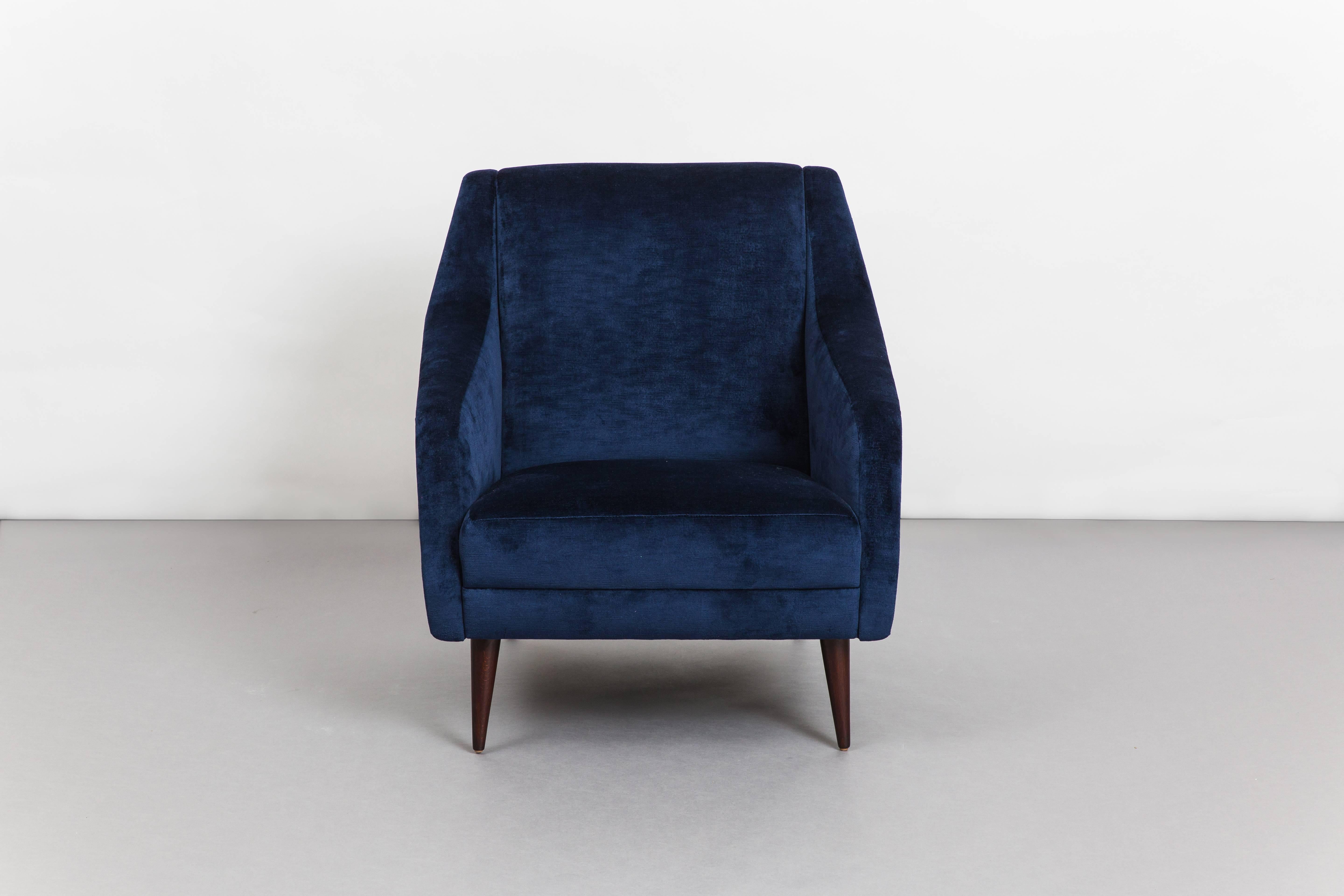 Carlo De Carli design for Cassina pair of sculptural armchairs or lounge chairs in navy velvet upholstery with stained beech legs. These armchairs are an iconic Carlo De Carli design with sleek architectural lines and great proportions for
