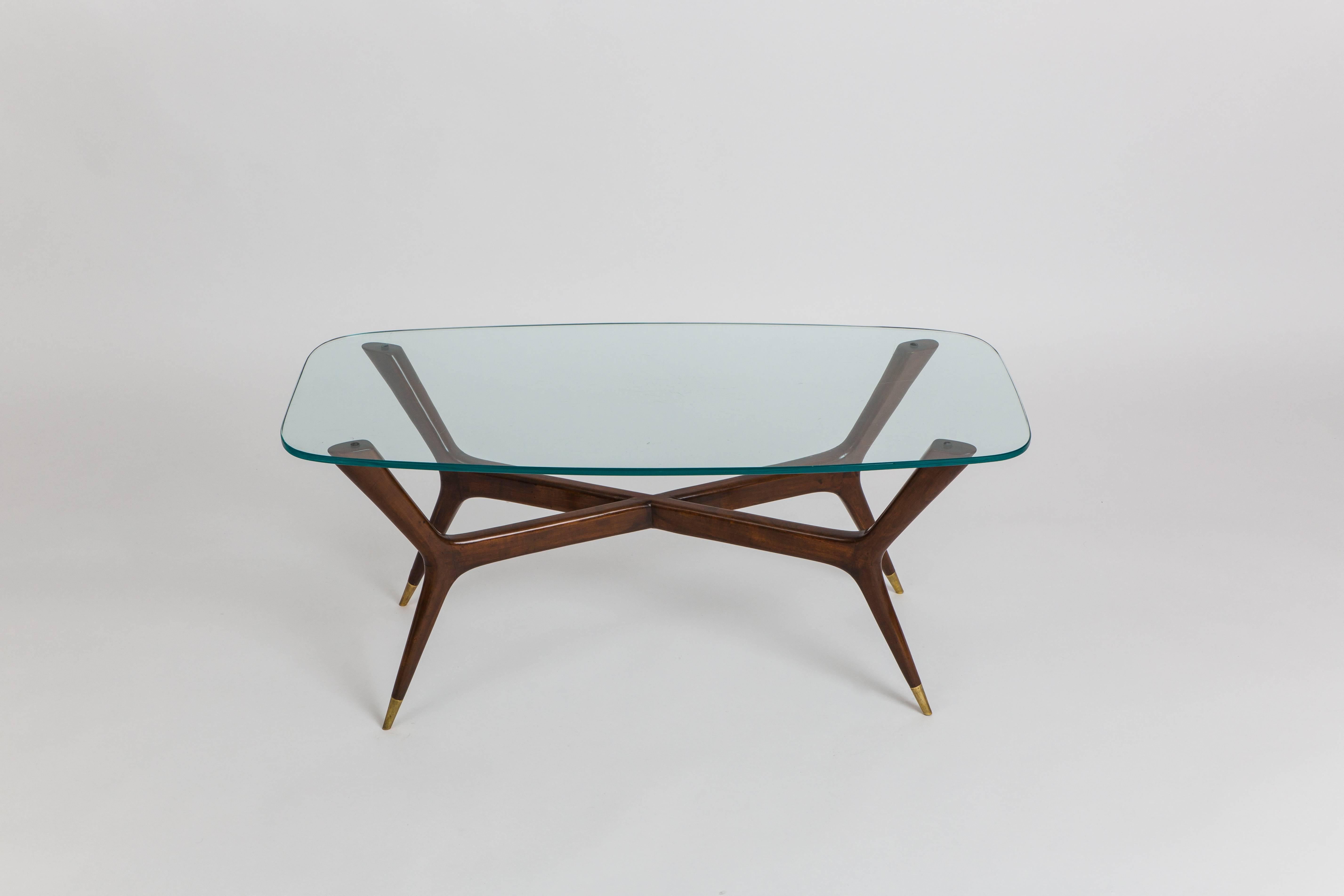 Gio Ponti elegant rare coffee table composed of sculptural Italian walnut legs ending in bronze sabots and thick glass top, Italy, 1950s.

Sold with Certificate of Authenticity from Gio Ponti archives.

Provenance:
Vedani office, Milan