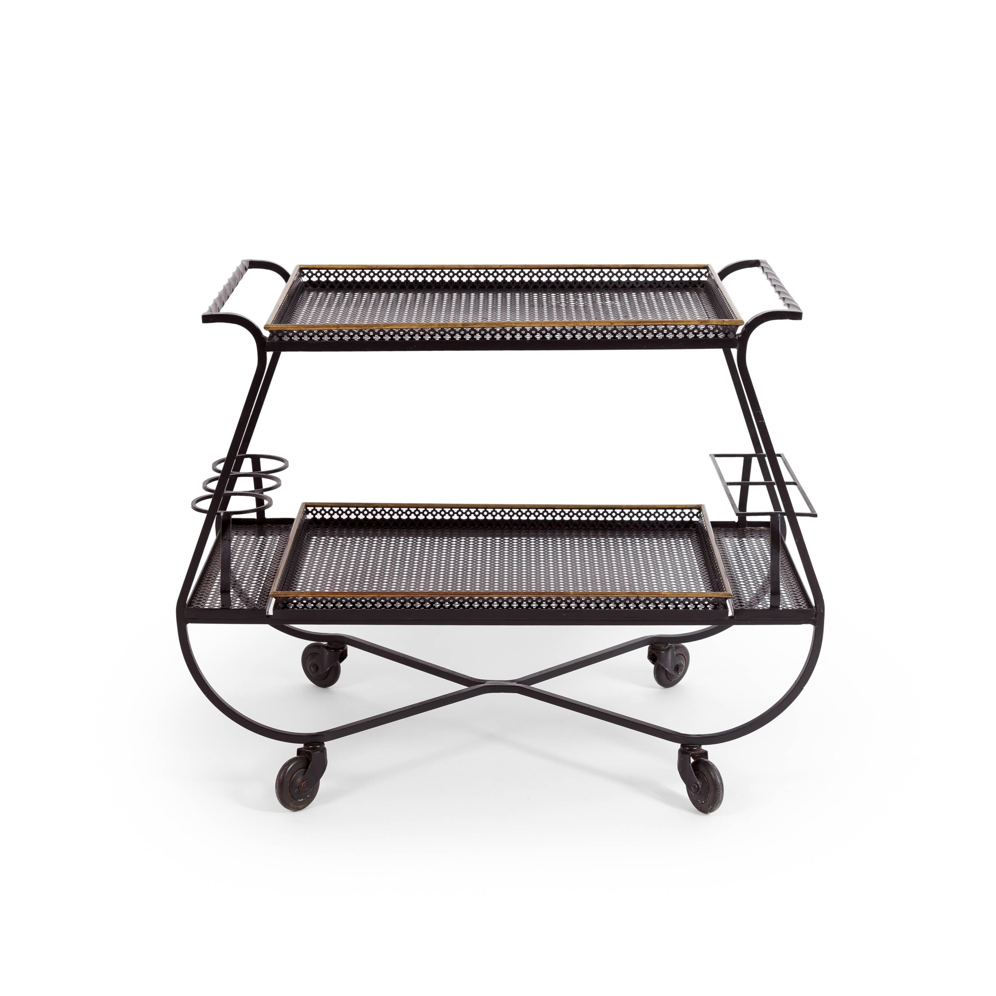 Mathieu Matégot chic and rare bar cart with elegantly curved black enameled and quadrifoil perforated metal tops, France, 1950s.
The top and bottom have removable trays with elegant brass details.

Literature: 
Patrick Favardin, Mathieu Matégot,