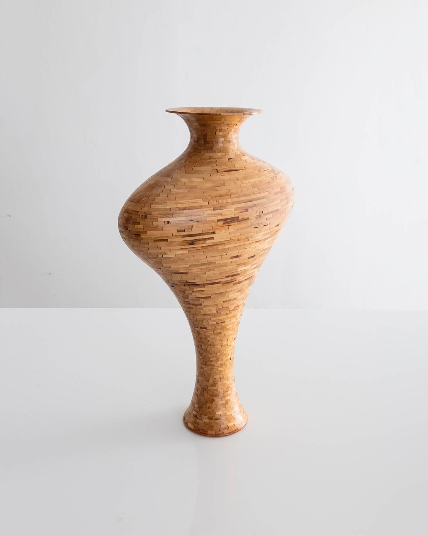 Part of Richard Haining's Stacked Collection, this vase was made using reclaimed Douglas fir salvaged from an Industrial farm building in the NYC area. The wood's natural coloring shows off tones ranging from light yellows and blonde to dark brown,