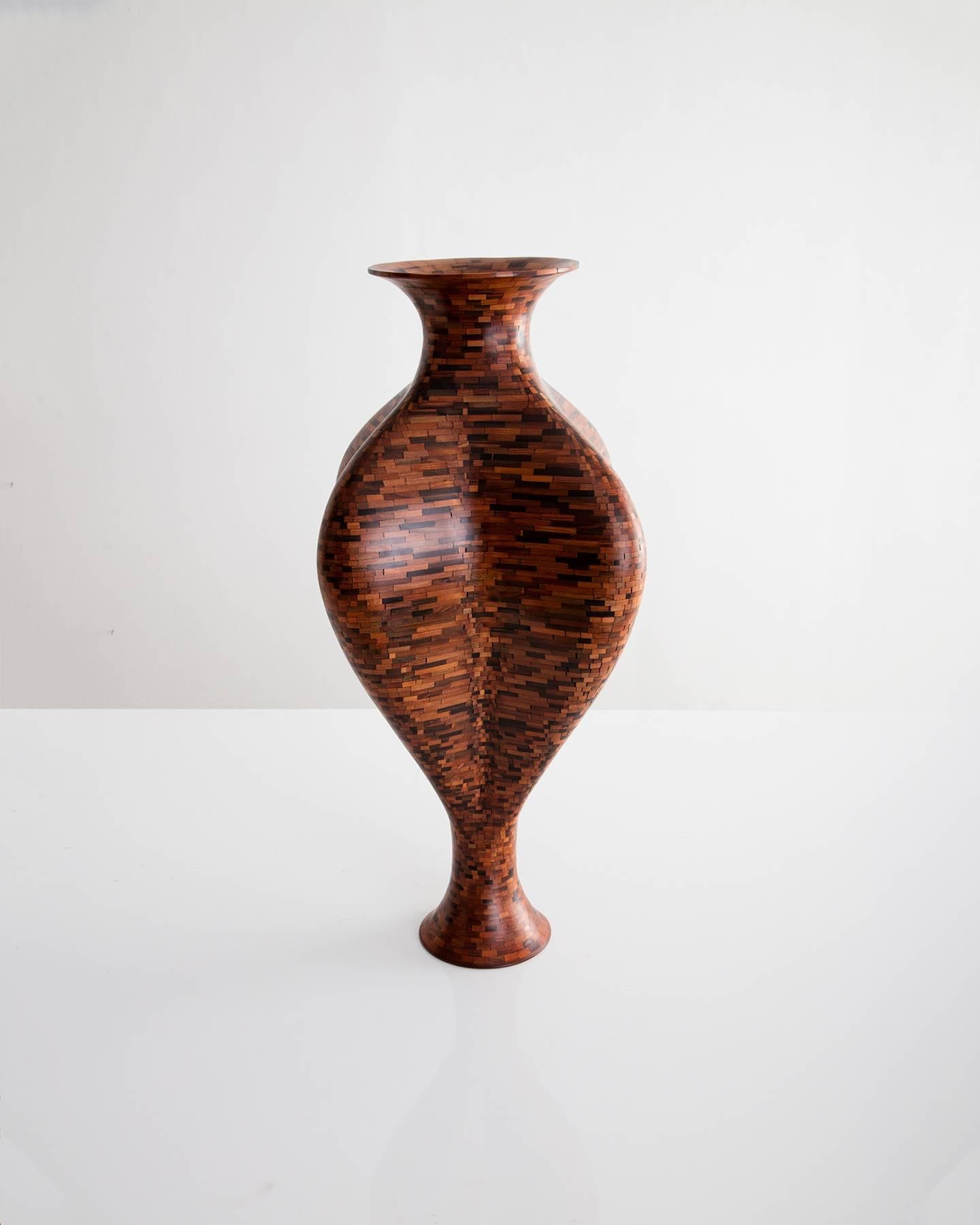 Part of Richard Haining's Stacked Collection, the wood in this vase was salvaged from a decommissioned NYC water tower. The wood's natural coloring shows off tones ranging from pink and deep reds to almost black in color. There is no stain involved.