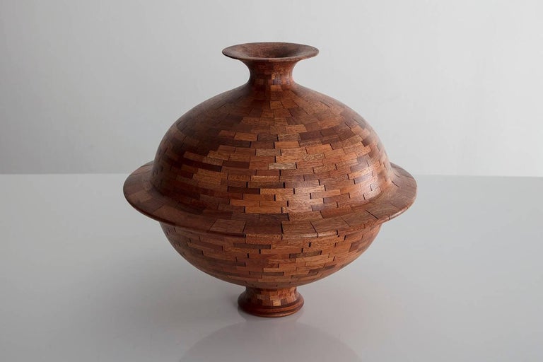Part of Richard Haining's STACKED Collection, this planetary like vessel utilizes salvaged mahogany sourced from a variety of places, including some from a sinker log from the Amazon River, some from an outdoor patio deck from Eastern Long Island