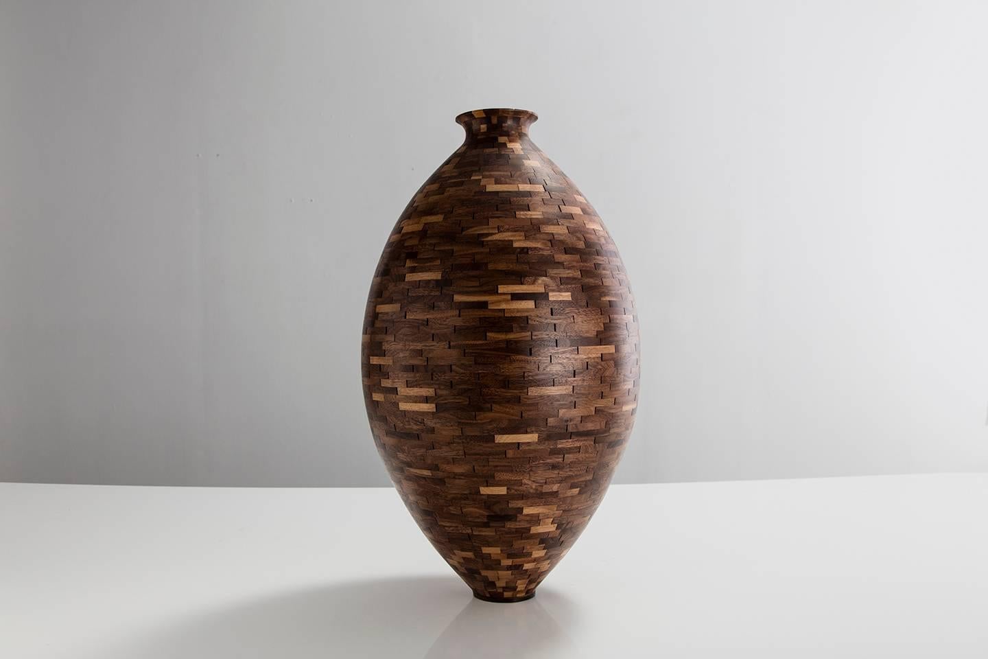 Part of Richard Haining's Stacked Collection, this traditional vase form was made using reclaimed walnut sourced and salvaged from a variety of local Brooklyn wood shops. The wood's natural coloring shows off warm tones ranging from mid to dark
