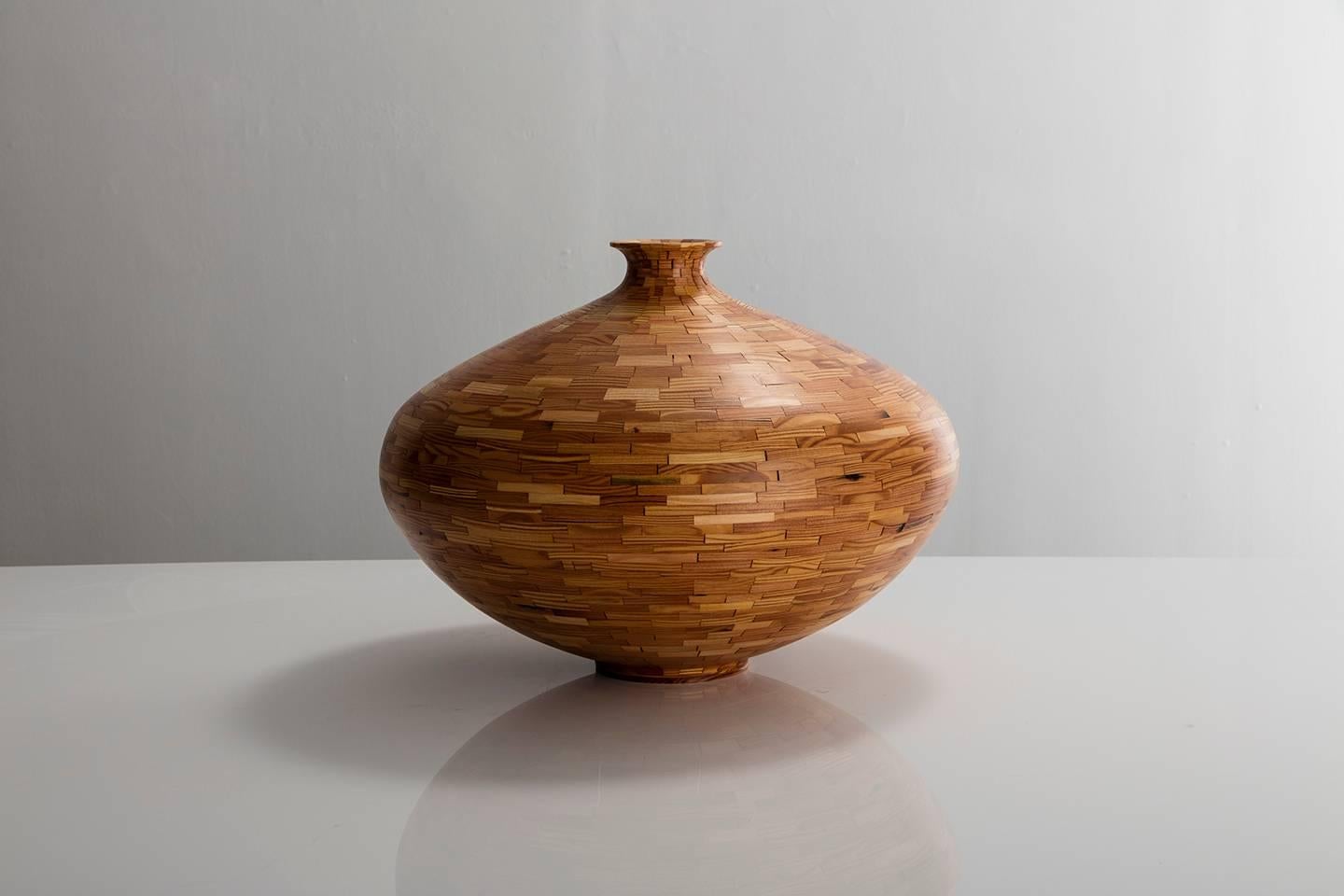 Part of Richard Haining's Stacked Collection, this saucer shaped vase was made using reclaimed Heart Pine, salvaged from a gutted Brooklyn Brownstone's building joist. The wood's natural coloring shows off tones ranging from light yellows and blonde