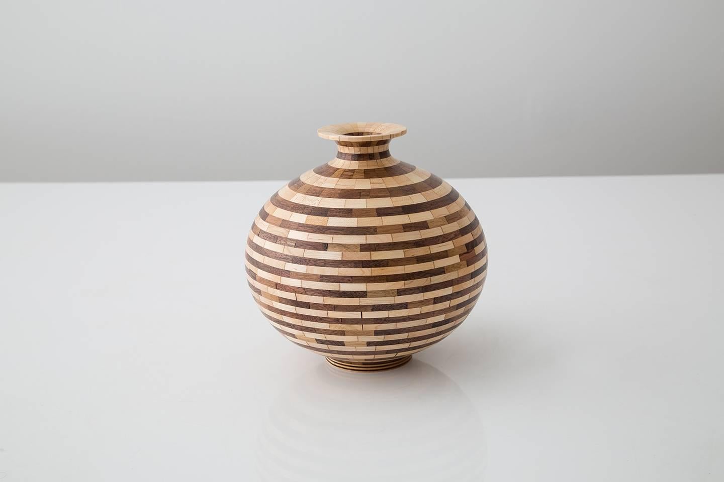 Part of Richard Haining's Stacked Collection, this round vase form was made using reclaimed walnut and maple, sourced and salvaged from a variety of local Brooklyn wood shops. The walnut and maple's contrasting natural colors shows off tones ranging