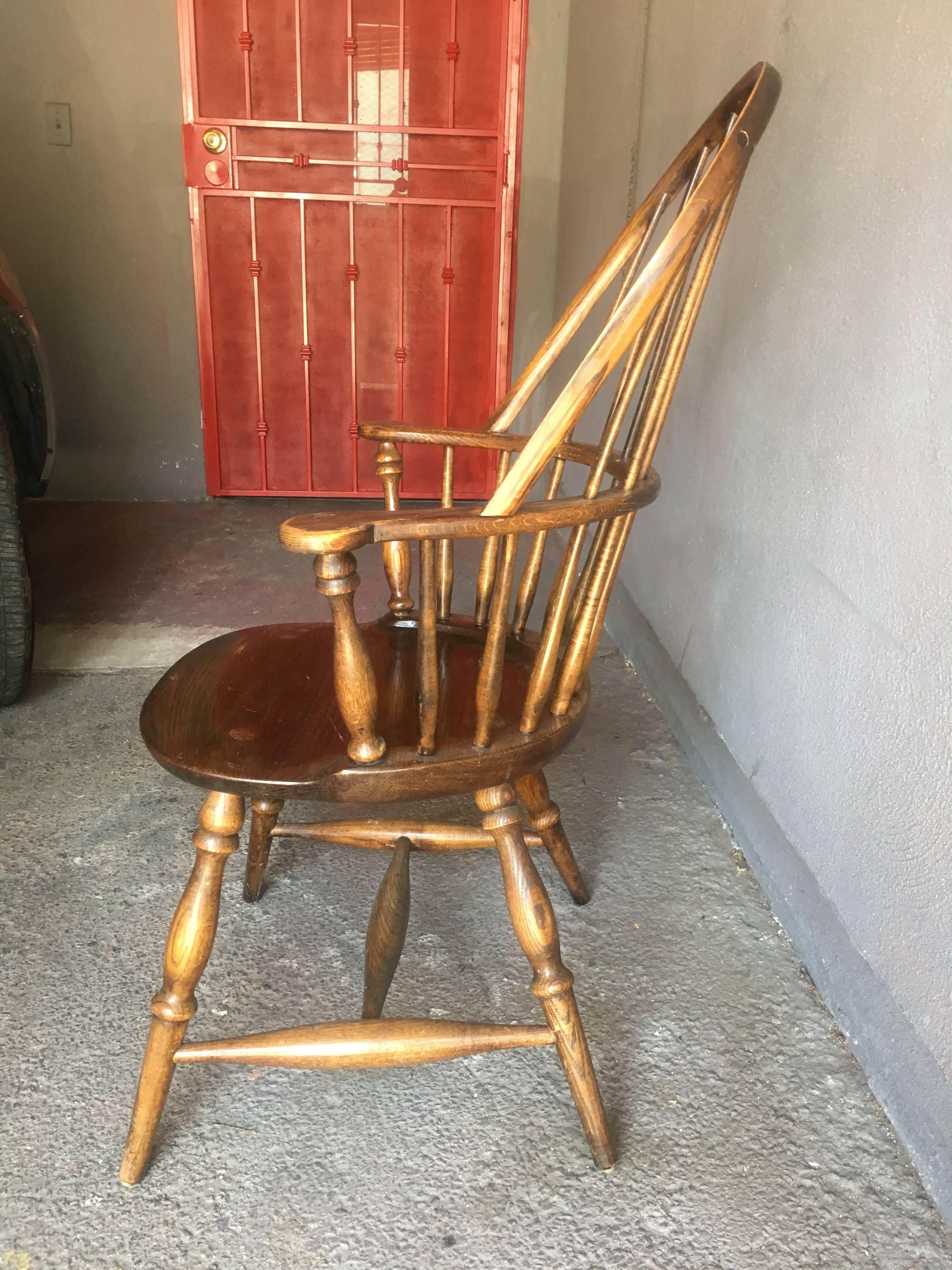 Set of four vintage solid oak windsor dining chairs consists of two armchairs and two side chairs. Stamped with H. W. Hull & Sons emblem.

Armchairs:
39
