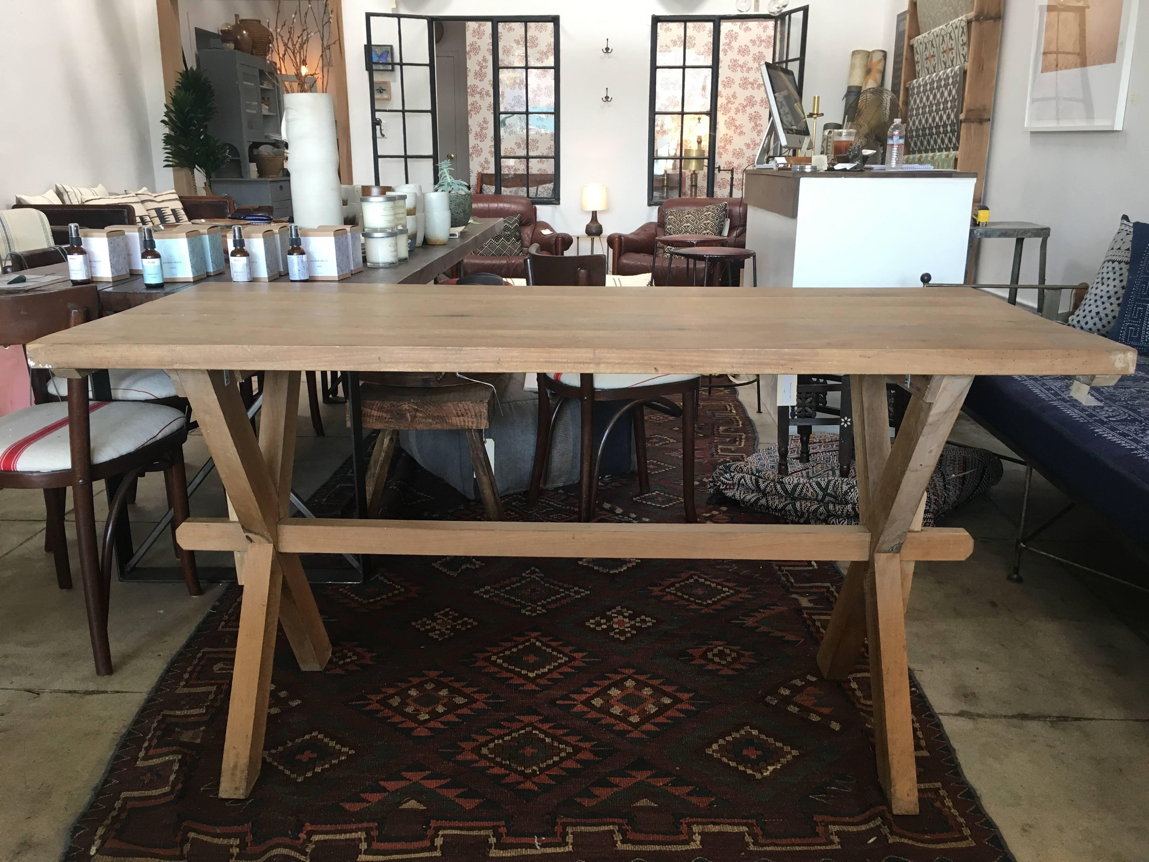 Vintage European trestle table. Beautiful natural grain enhances the appearance of this light, unfinished wood. X-base legs with horizontal support beam. Great dining table or work table.