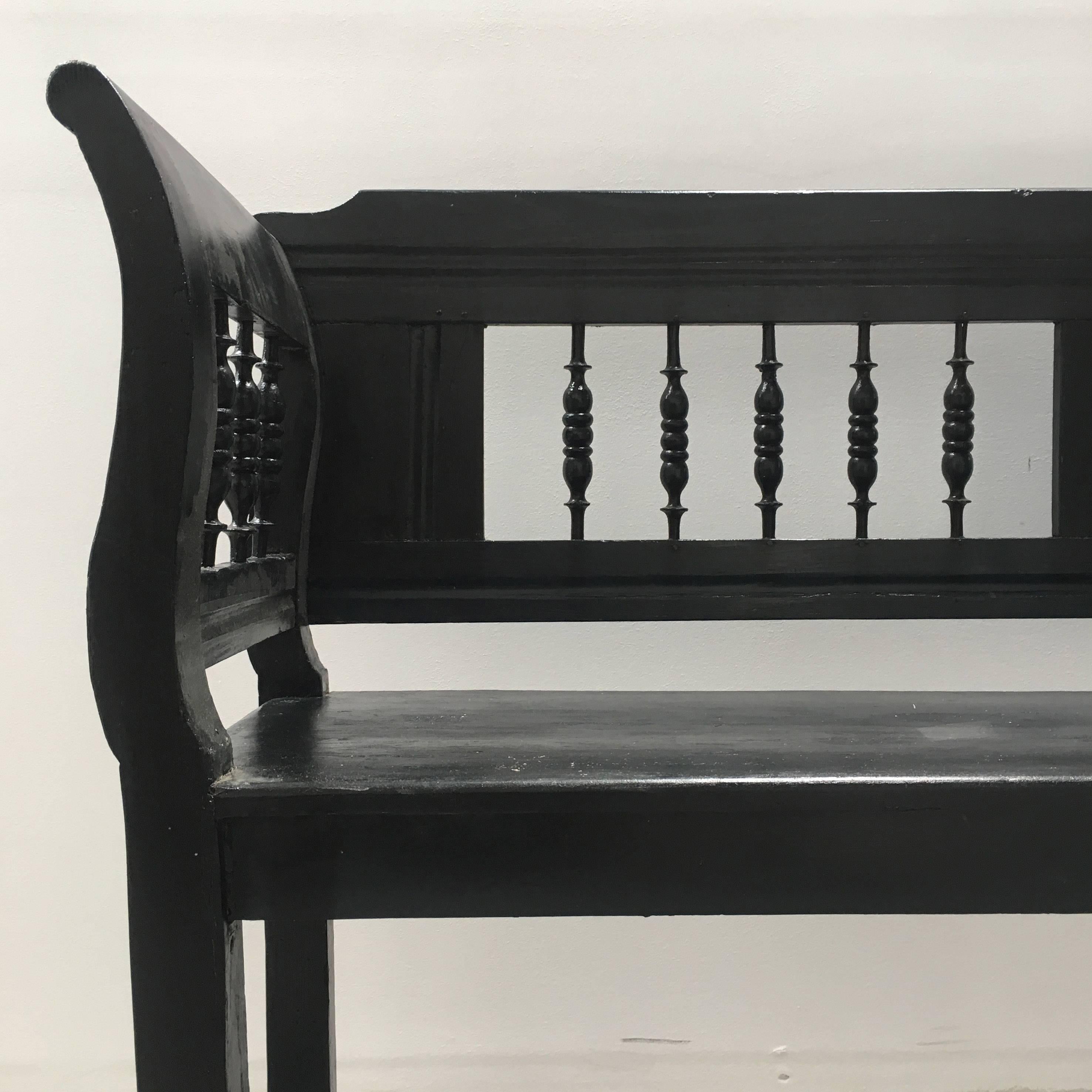Stunning wooden bench from early 1900s, Europe. Painted black with carved details and sumptuous curved armrests. Perfect as is, adorn with pillows, or ask us about creating a custom cushion!
