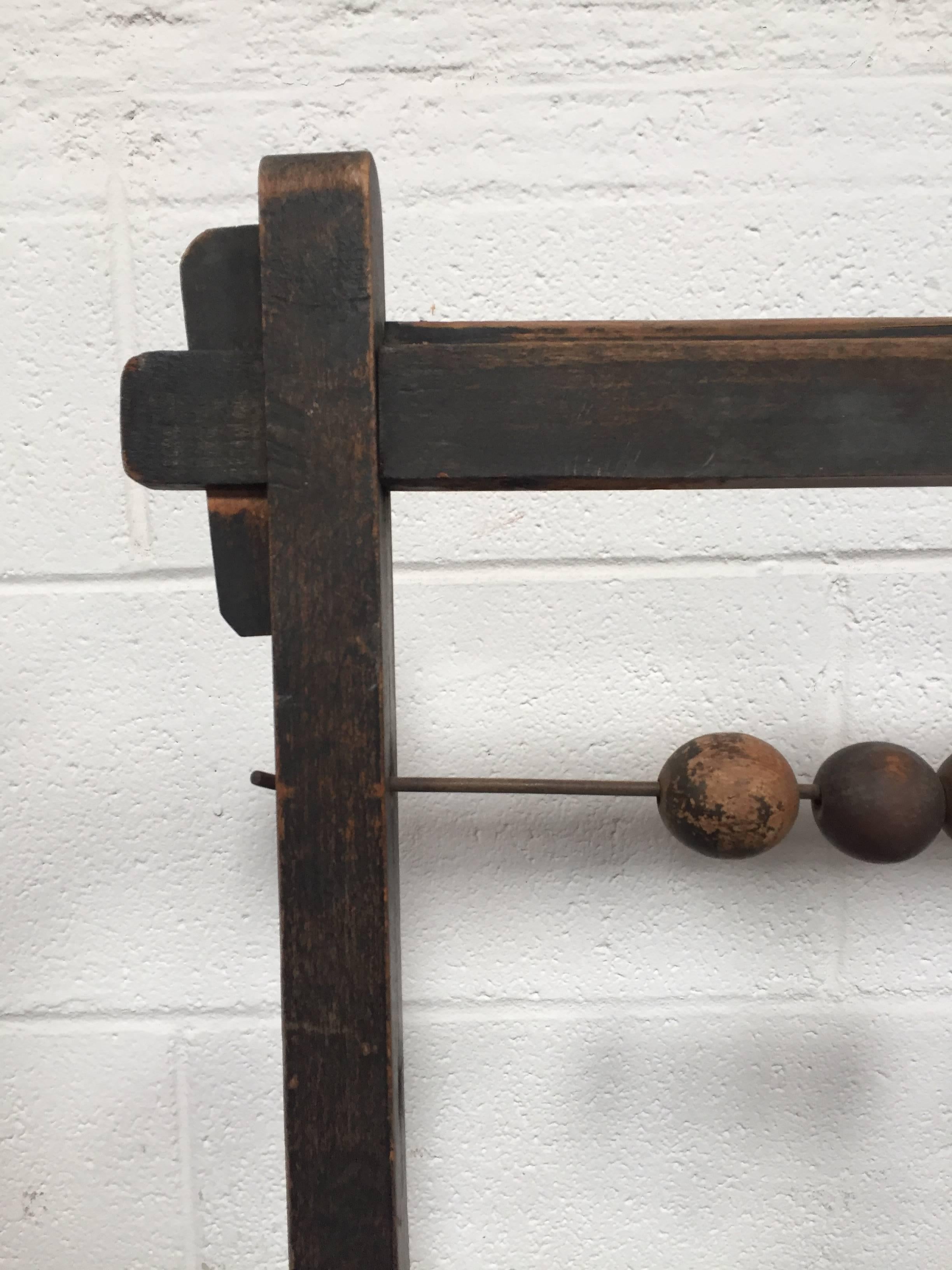 Working Abacus with wooden counting balls from early 20th century, some of the wires are bent with age, but stands upright and sturdy. 

Wonderful as a set or store display piece.